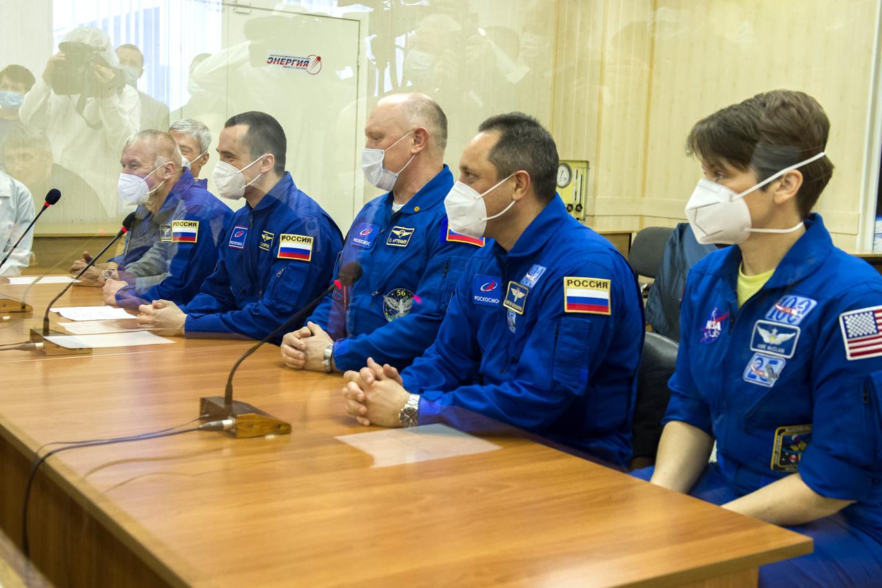 Expedition 65 prime crew members NASA astronaut Mark Vande Hei, far left, and Russian cosmonauts Oleg Novitskiy, second left, and Pyotr Dubrov of Roscosmos, center, are seen with backup crew members Russian cosmonauts Oleg Artemyev, third from right, and Anton Shkaplerov of Roscosmos, second from right, and NASA astronaut Anne McClain while speaking with mission managers during the final Soyuz MS-18 spacecraft fit check, Sunday, April 4, 2021 at the Baikonur Cosmodrome in Kazakhstan. The prime crew is scheduled to launch to the International Space Station on a Soyuz rocket April 9. Photo Credit: (NASA/GCTC/Irina Spector)