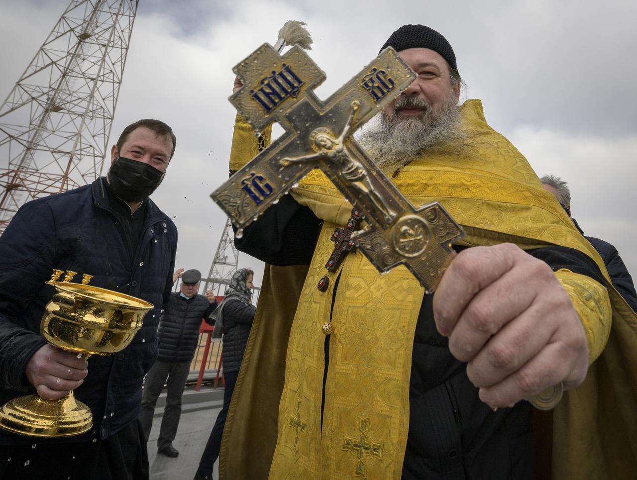 Russian Orthodox Priest Father Sergei blesses mission support personnel at the Baikonur Cosmodrome launch pad after having blessed the Soyuz rocket, Thursday, April 8, 2021, in Kazakhstan. Expedition 65 NASA astronaut Mark Vande Hei, Roscosmos cosmonauts Pyotr Dubrov and Oleg Novitskiy are scheduled to launch aboard their Soyuz MS-18 spacecraft on April 9.  Photo Credit: (NASA/Bill Ingalls)