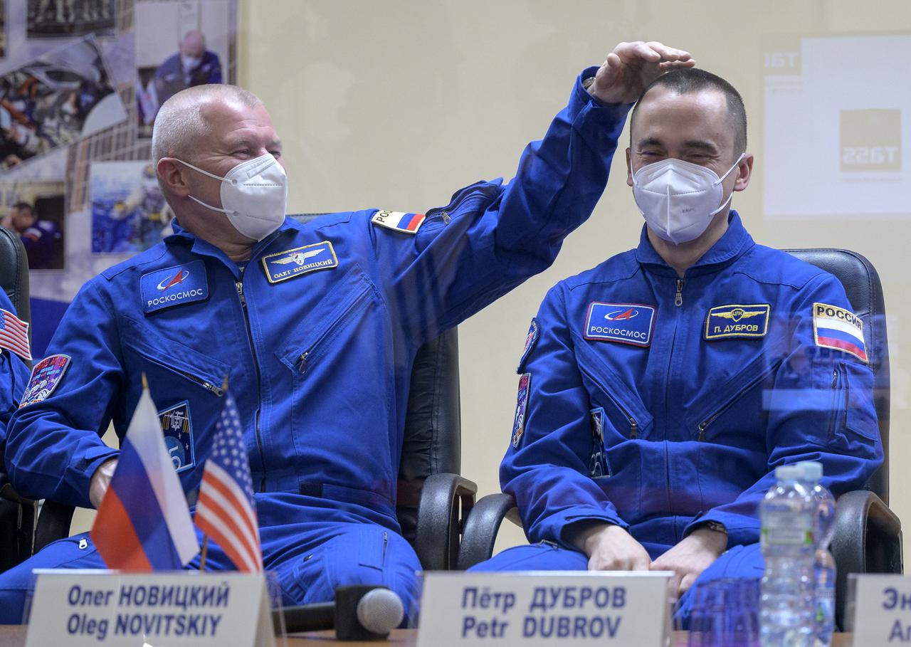 Roscosmos cosmonauts Oleg Novitskiy and Pyotr Dubrov laugh during a press conference, Thursday, April 8, 2021 a the Cosmonaut Hotel in Baikonur, Kazakhstan. Expedition 65 NASA astronaut Mark Vande Hei, Novitskiy and Dubrov are scheduled to launch to the International Space Station aboard the Soyuz MS-18 spacecraft on April 9.  Photo Credit: (NASA/Bill Ingalls)