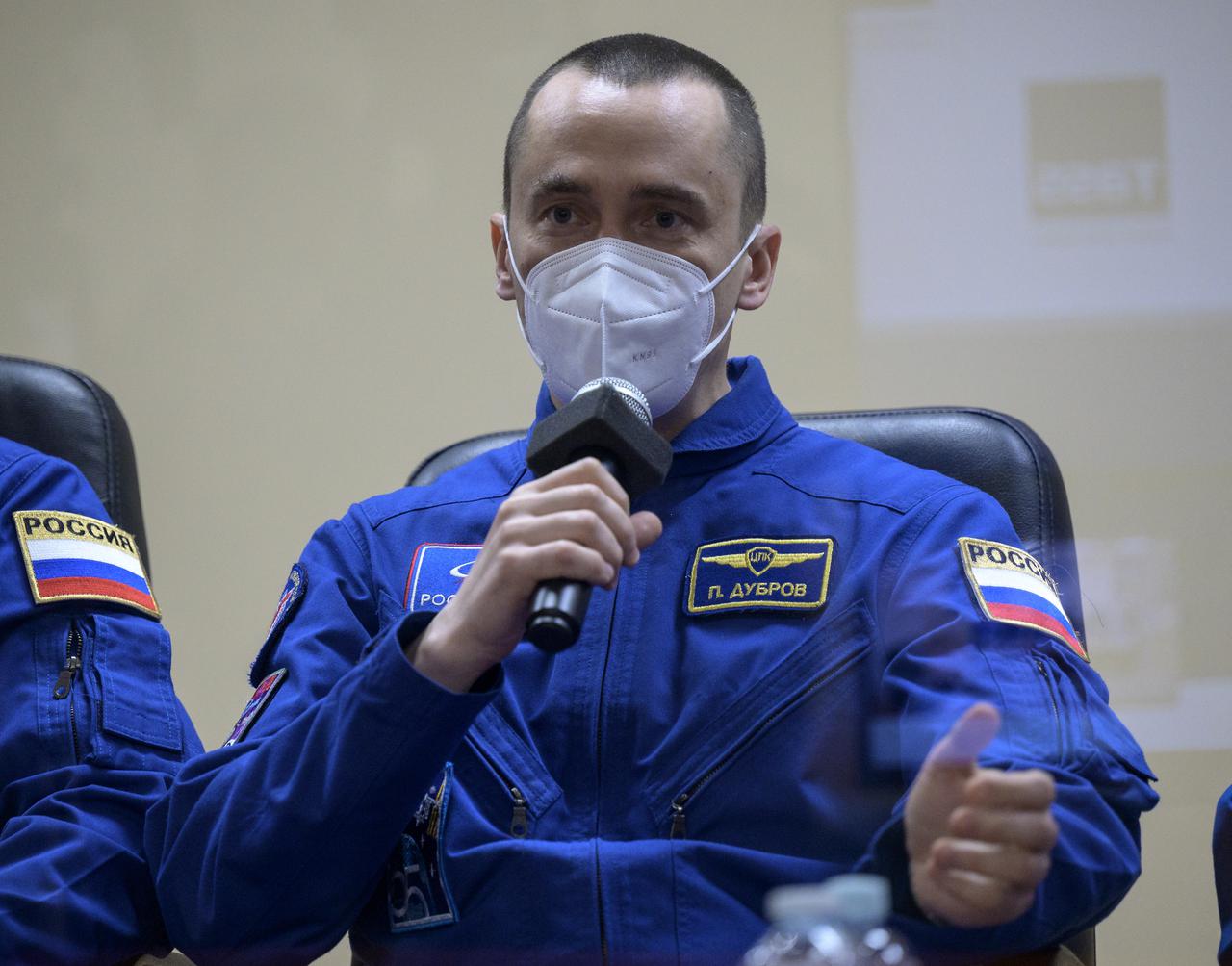 Expedition 65 Russian cosmonaut Pyotr Dubrov is seen in quarantine, behind glass, during a press conference, Thursday, April 8, 2021 a the Cosmonaut Hotel in Baikonur, Kazakhstan. Expedition 65 NASA astronaut Mark Vande Hei, Roscosmos cosmonauts Oleg Novitskiy and Dubrov are scheduled to launch to the International Space Station aboard the Soyuz MS-18 spacecraft on April 9.  Photo Credit: (NASA/Bill Ingalls)