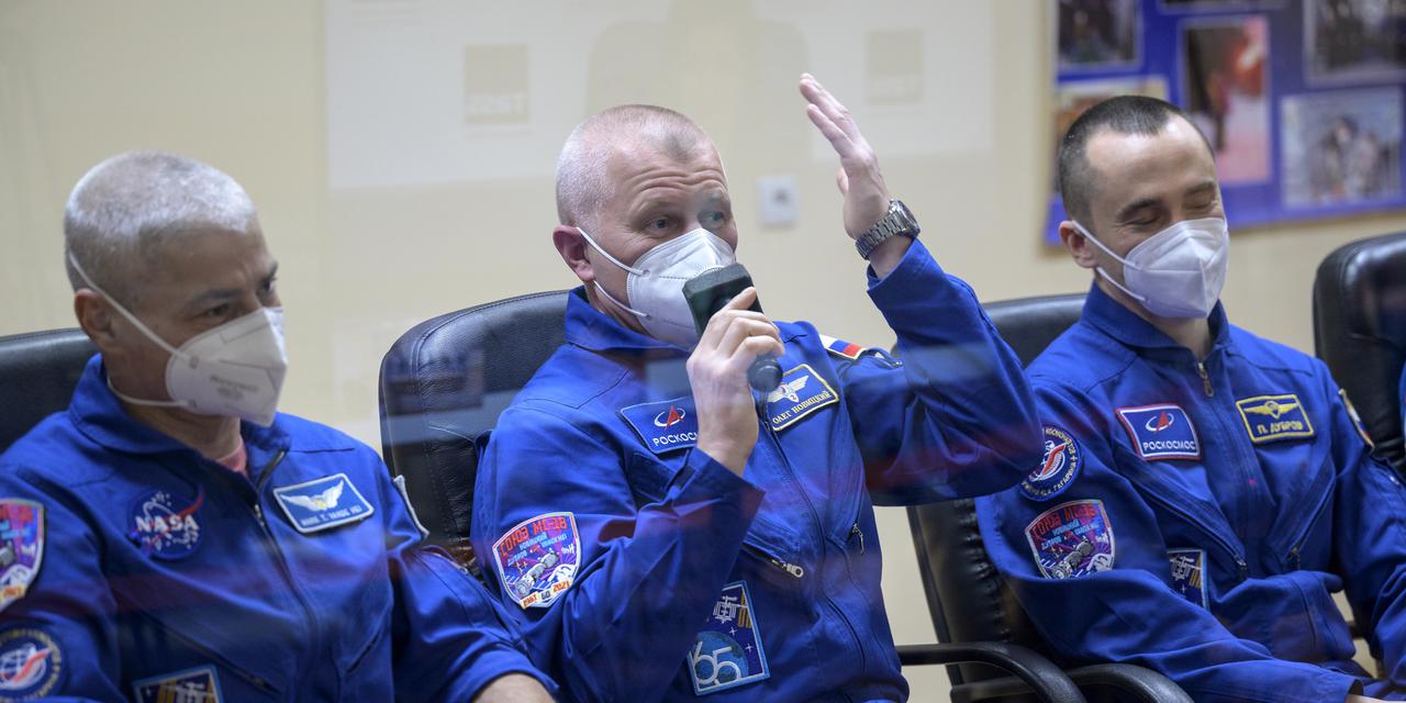 Expedition 65 NASA astronaut Mark Vande Hei, left, Roscosmos cosmonauts Oleg Novitskiy and Pyotr Dubrov, right, are seen in quarantine, behind glass, during a press conference, Thursday, April 8, 2021 a the Cosmonaut Hotel in Baikonur, Kazakhstan. The trio are scheduled to launch to the International Space Station aboard the Soyuz MS-18 spacecraft on April 9.  Photo Credit: (NASA/Bill Ingalls)