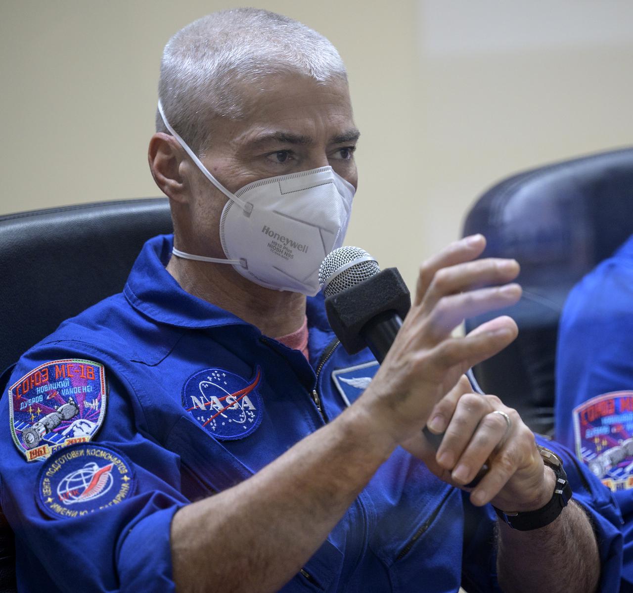 Expedition 65 NASA astronaut Mark Vande Hei, is seen in quarantine, behind glass, during a press conference, Thursday, April 8, 2021 a the Cosmonaut Hotel in Baikonur, Kazakhstan. Vande Hei and fellow Expedition 65 crewmembers Pyotr Dubrov and Oleg Novitskiy of Roscosmos are scheduled to launch to the International Space Station aboard the Soyuz MS-18 spacecraft on April 9. Photo Credit: (NASA/Bill Ingalls)