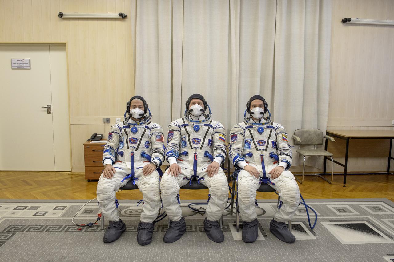 Expedition 65 NASA astronaut Mark Vande Hei, left, Russian cosmonauts Oleg Novitskiy, center, and Pyotr Dubrov pose for a group photo after donning their Russian Sokol suits ahead of their Soyuz launch to the International Space Station Friday, April 9, 2021 in Baikonur, Kazakhstan. Launch of the Soyuz rocket sent the trio on a mission to the International Space Station. Photo Credit: (NASA/GCTC/Irina Spector)