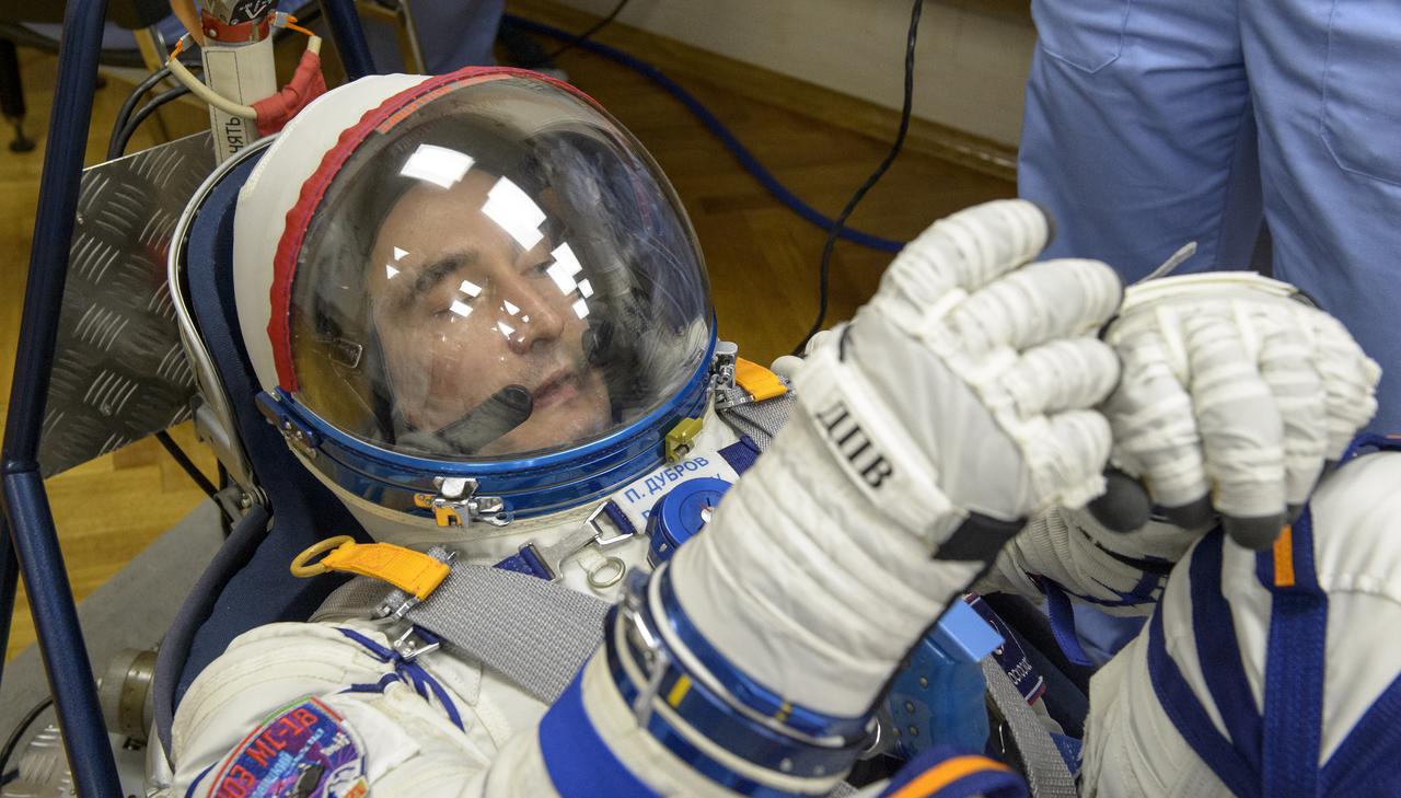 Expedition 65 Russian cosmonaut Pyotr Dubrov has his Russian Sokol suit pressure checked as he and fellow crewmates NASA astronaut Mark Vande Hei and Russian cosmonaut Oleg Novitskiyprepare for their Soyuz launch to the International Space Station Friday, April 9, 2021 in Baikonur, Kazakhstan. Launch of the Soyuz rocket sent the trio on a mission to the International Space Station. Photo Credit: (NASA/GCTC/Irina Spector)