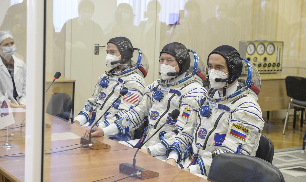 Expedition 65 NASA astronaut Mark Vande Hei, left, Russian cosmonauts Oleg Novitskiy, center, and Pyotr Dubrov talk with mission management prior to their Soyuz launch to the International Space Station Friday, April 9, 2021 in Baikonur, Kazakhstan. Photo Credit: (NASA/GCTC/Irina Spector)