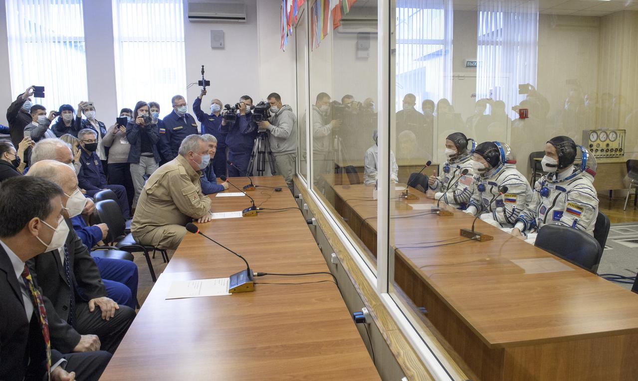 Expedition 65 NASA astronaut Mark Vande Hei, left, Russian cosmonauts Oleg Novitskiy, center, and Pyotr Dubrov talk with Roscosmos and NASA mission management prior to their Soyuz launch to the International Space Station Friday, April 9, 2021 in Baikonur, Kazakhstan. Photo Credit: (NASA/GCTC/Irina Spector)