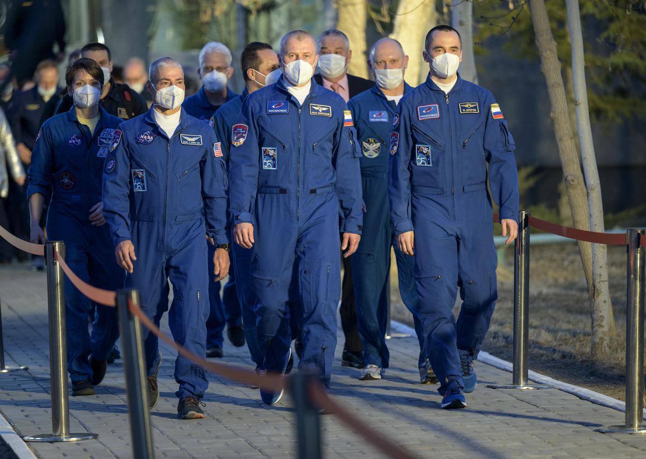 Expedition 65 NASA astronaut Mark Vande Hei, Roscosmos cosmonauts Oleg Novitskiy and Pyotr Dubrov depart the Cosmonaut Hotel to suit-up for their Soyuz launch to the International Space Station, Friday, April 9, 2021, in Baikonur, Kazakhstan. Later that same day the crew launched in their Soyuz MS-18 spacecraft to the International Space Station. Photo Credit: (NASA/Bill Ingalls)