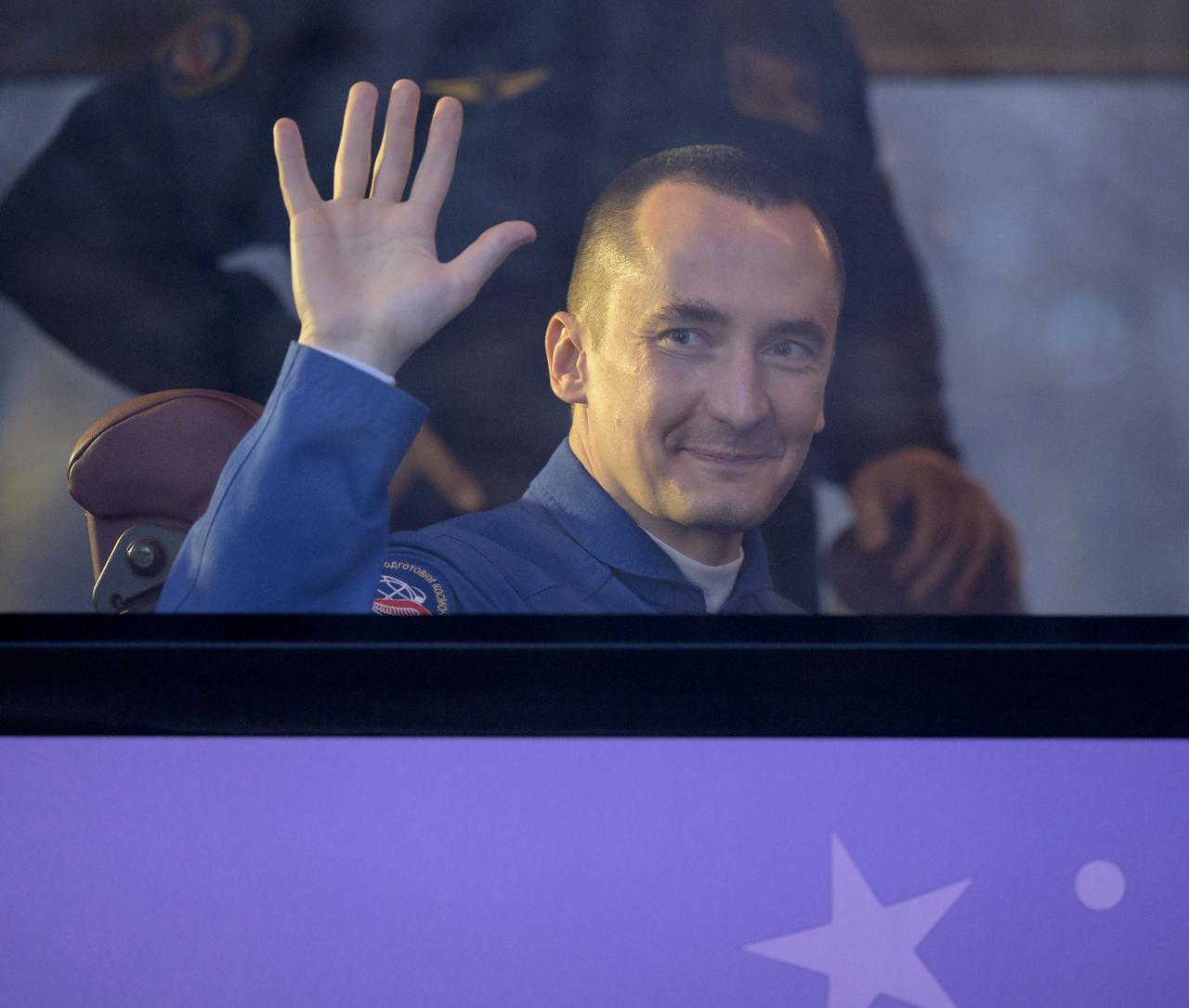 Expedition 65 Russian cosmonaut Pyotr Dubrov waves as he departs the Cosmonaut Hotel to suit-up with Russian cosmonaut Oleg Novitskiy and NASA astronaut Mark Vande Hei for their Soyuz launch to the International Space Station, Friday, April 9, 2021, in Baikonur, Kazakhstan. Photo Credit: (NASA/Bill Ingalls)
