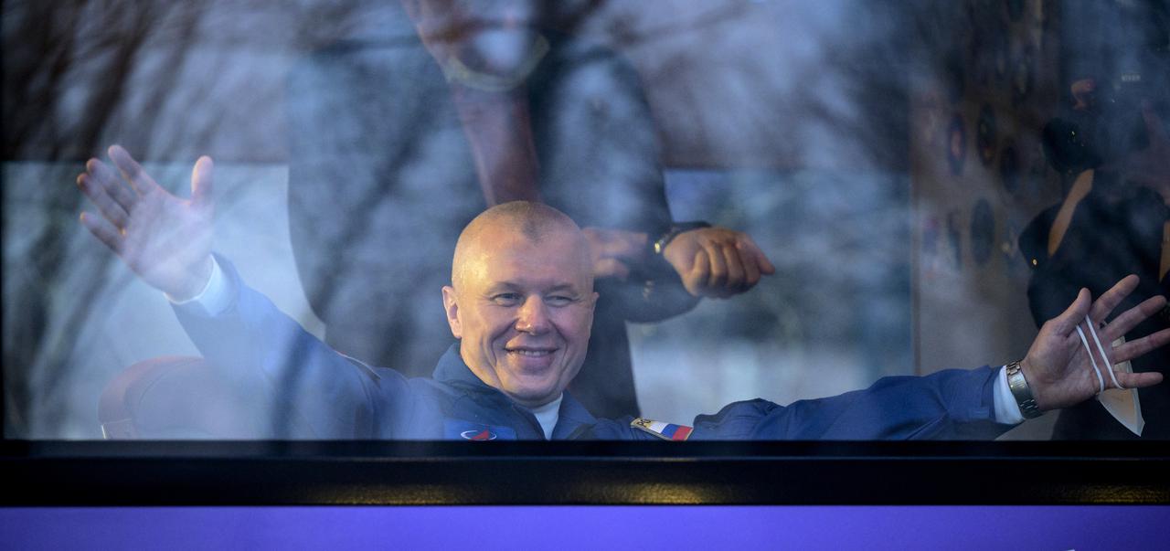 Expedition 65 Russian cosmonaut Oleg Novitskiy gives a virtual hug as he departs the Cosmonaut Hotel to suit-up with Russian cosmonaut Pyotr Dubrov and NASA astronaut Mark Vande Hei for their Soyuz launch to the International Space Station, Friday, April 9, 2021, in Baikonur, Kazakhstan. Photo Credit: (NASA/Bill Ingalls)