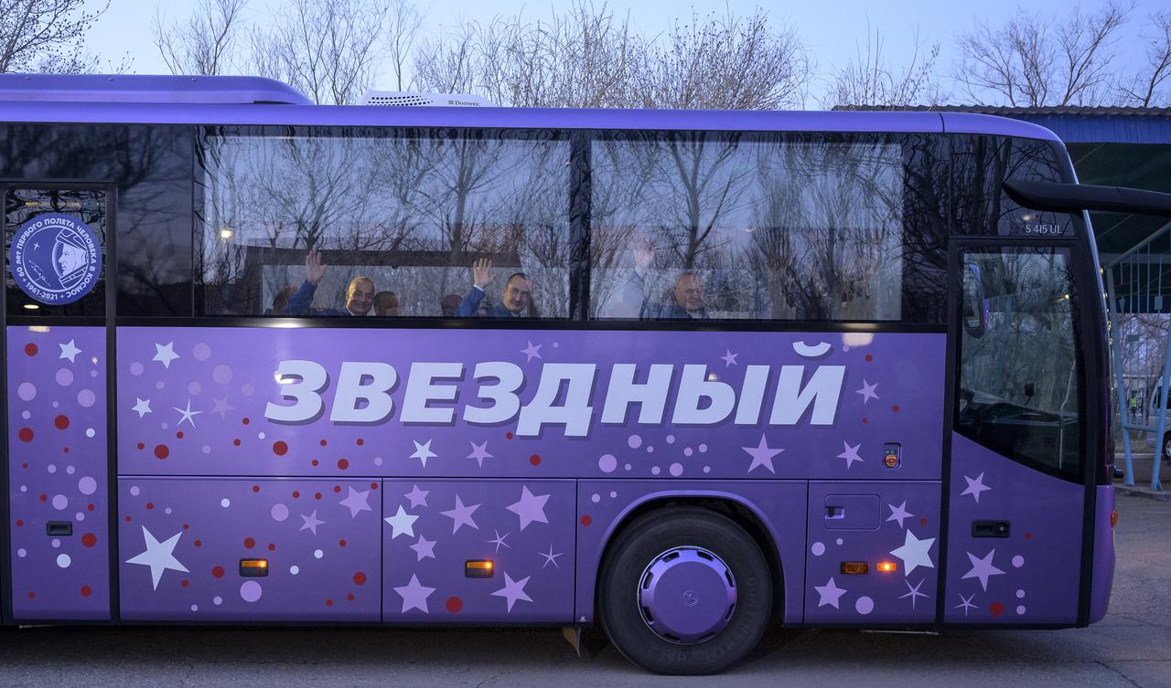 Expedition 65 NASA astronaut Mark Vande Hei, left, Roscosmos cosmonauts Oleg Novitskiy, center, and Pyotr Dubrov wave as they depart the Cosmonaut Hotel to suit-up for their Soyuz launch to the International Space Station, Friday, April 9, 2021, in Baikonur, Kazakhstan. Photo Credit: (NASA/Bill Ingalls)