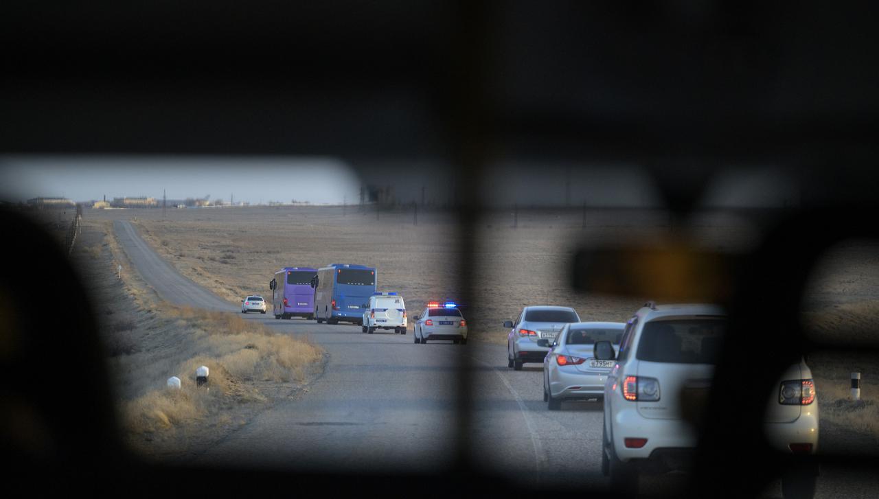 Expedition 65 prime and backup crew buses are escorted across the Baikonur Cosmodrome to building 254 for the prime crewmembers to don their Russian Sokol suits ahead of their Soyuz launch to the International Space Station Friday, April 9, 2021 in Baikonur, Kazakhstan. Photo Credit: (NASA/Bill Ingalls)