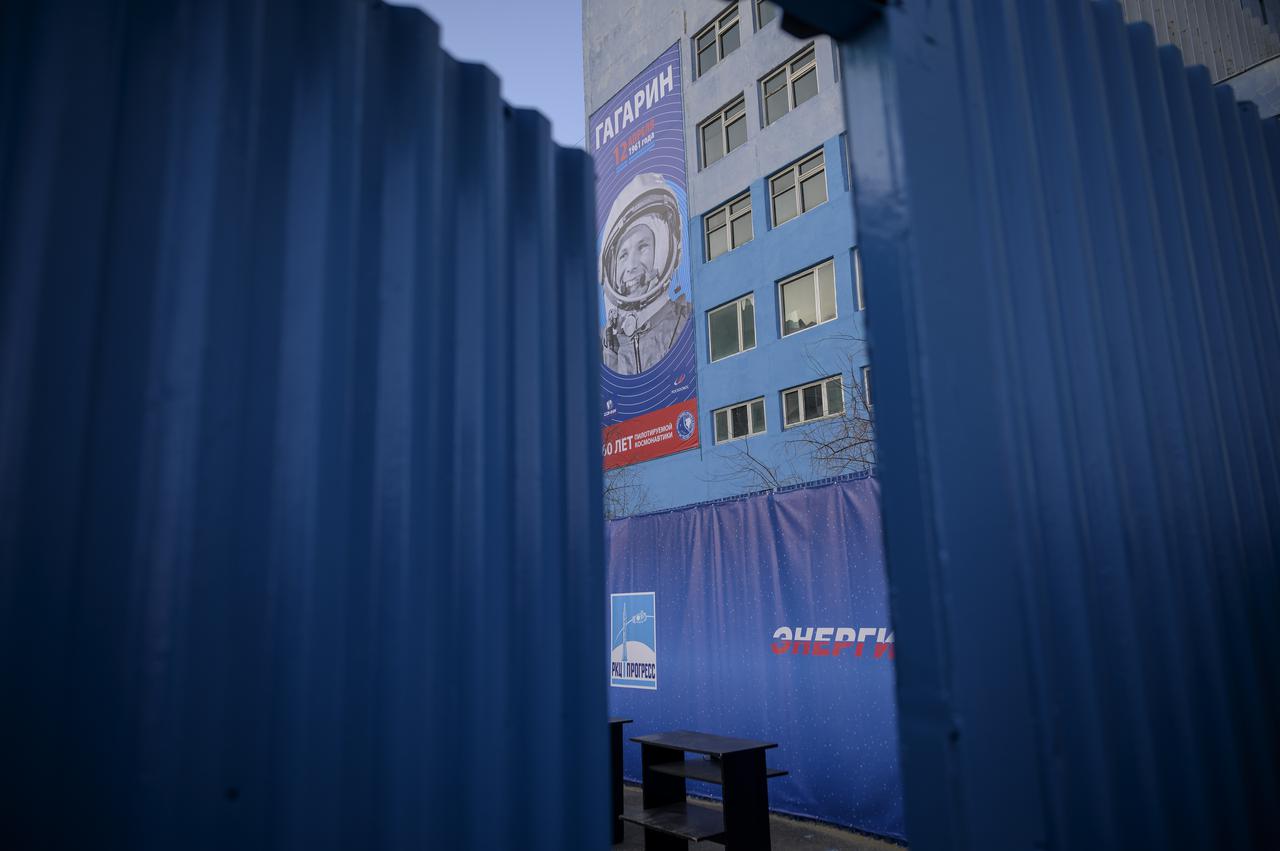 A banner celebrating the 60th anniversary of the launch of Yuri Gagarin is seen just past the security entrance to building 254 of the Baikonur Cosmodrome, Friday, April 9, 2021 in Baikonur, Kazakhstan. Launch of the Soyuz rocket sent Expedition 65 NASA astronaut Mark Vande Hei, Russian cosmonauts Oleg Novitskiy and Pyotr Dubrov on a mission to the International Space Station. Photo Credit: (NASA/Bill Ingalls)