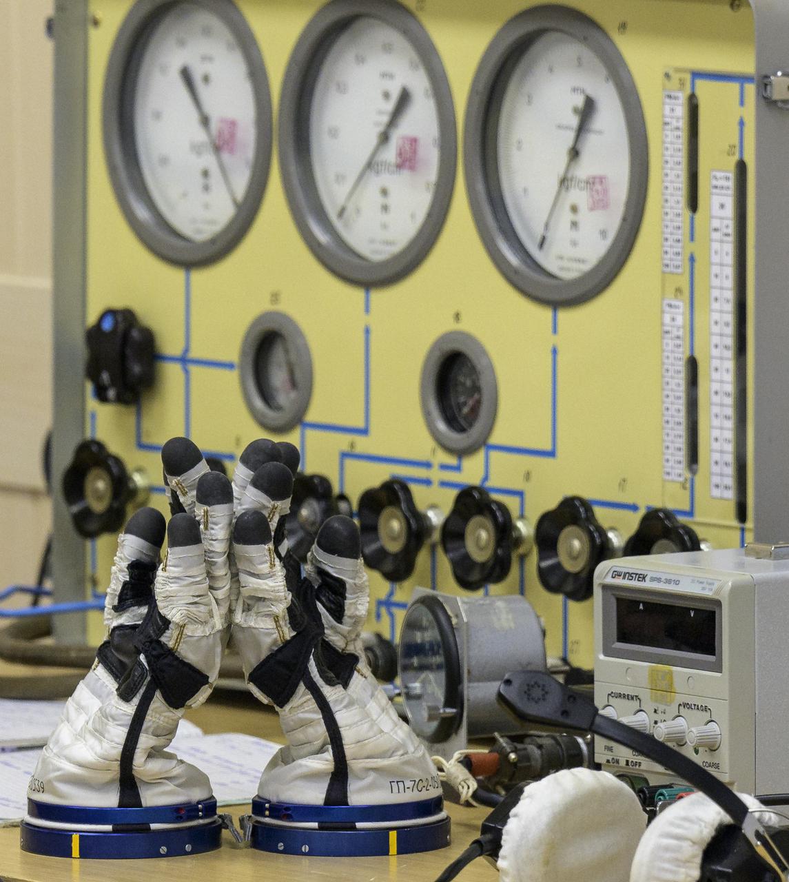 Russian Sokol suit gloves and pressure testing equipment are in place for Expedition 65 NASA astronaut Mark Vande Hei, Russian cosmonauts Oleg Novitskiy and Pyotr Dubrov as they prepare for their Soyuz launch to the International Space Station Friday, April 9, 2021 in Baikonur, Kazakhstan. Launch of the Soyuz rocket sent the trio on a mission to the International Space Station. Photo Credit: (NASA/Bill Ingalls)