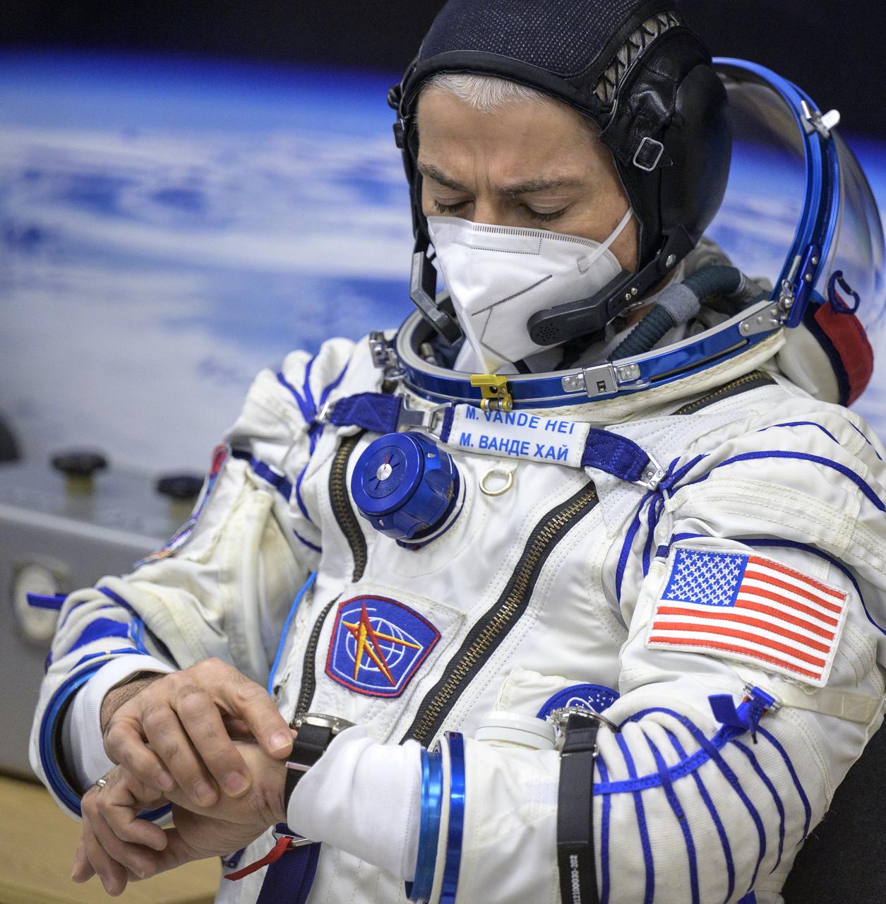 Expedition 65 NASA astronaut Mark Vande Hei checks his watch after donning his Russian Sokol suit as he and fellow crewmates Russian cosmonauts Oleg Novitskiy and Pyotr Dubrov, prepare for their Soyuz launch to the International Space Station Friday, April 9, 2021 in Baikonur, Kazakhstan. Launch of the Soyuz rocket sent the trio on a mission to the International Space Station. Photo Credit: (NASA/Bill Ingalls)