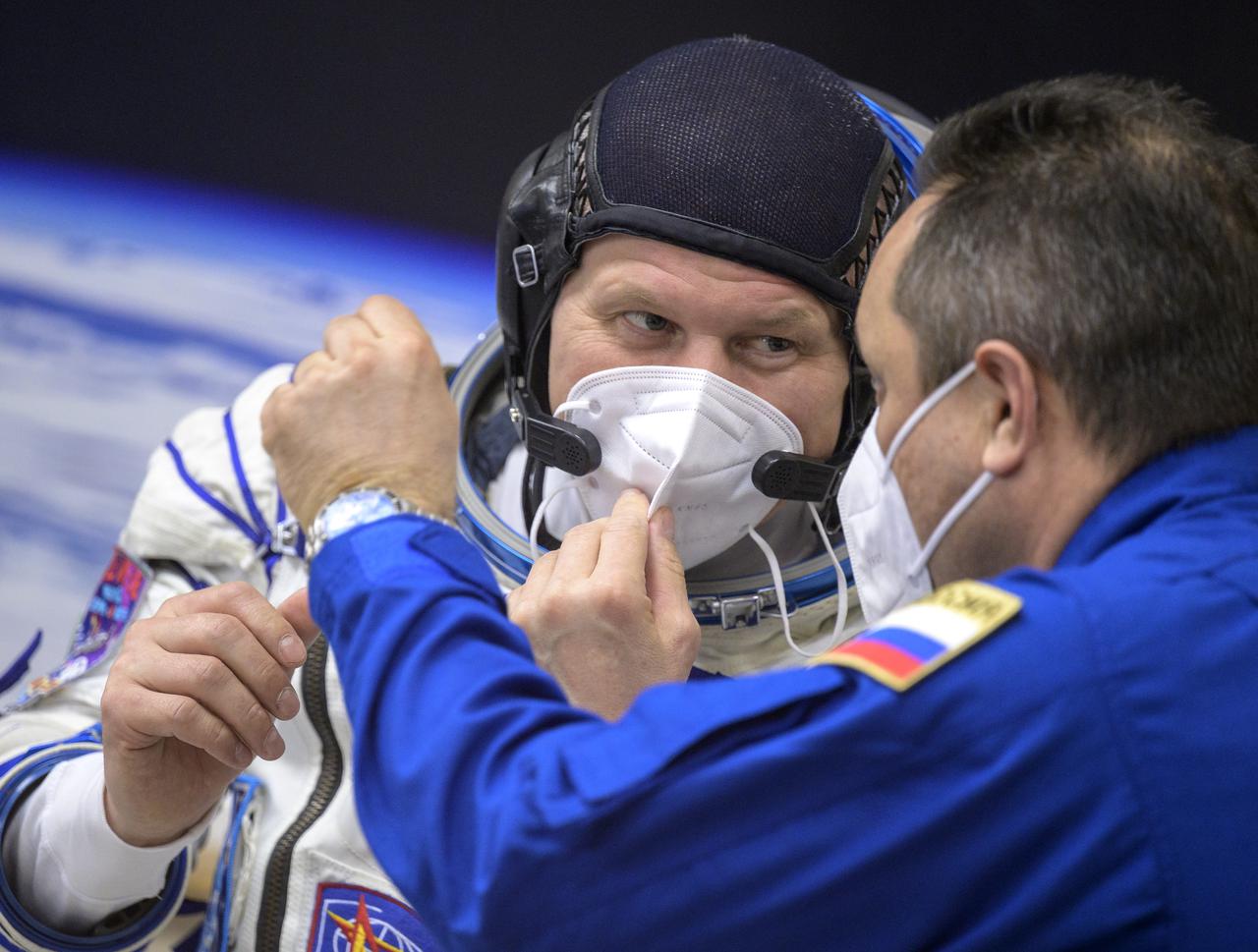 Expedition 65 Russian cosmonaut Oleg Novitskiy, left, talks with Expedition 65 backup crewmember Anton Shkaplerov of Roscosmos after donning his Russian Sokol suit as he and fellow crewmates Russian cosmonaut Pyotr Dubrov and NASA astronaut Mark Vande Hei, prepare for their Soyuz launch to the International Space Station Friday, April 9, 2021 in Baikonur, Kazakhstan. Launch of the Soyuz rocket sent the trio on a mission to the International Space Station. Photo Credit: (NASA/Bill Ingalls)