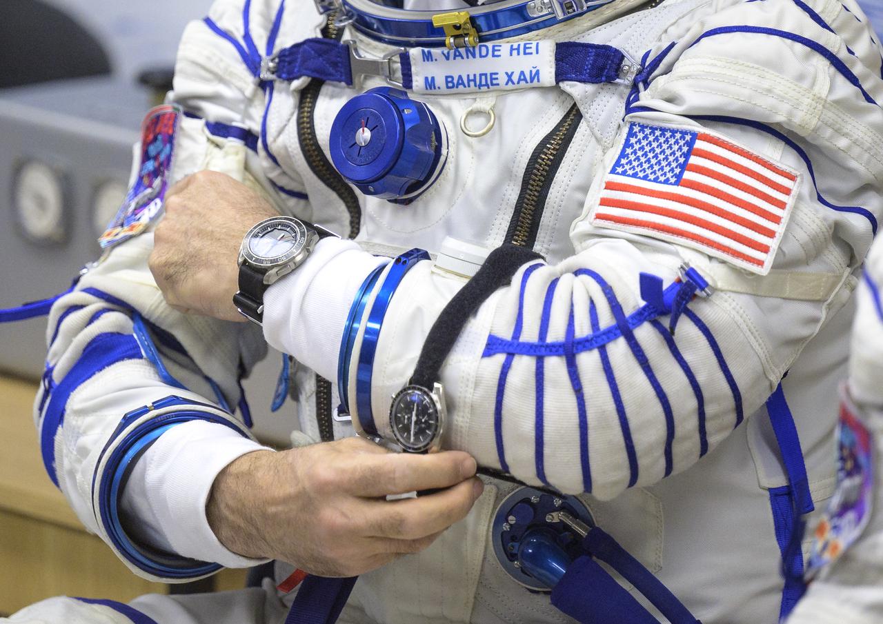Expedition 65 NASA astronaut Mark Vande Hei adjust one of his watches after donning his Russian Sokol suit as he and fellow crewmates Russian cosmonauts Oleg Novitskiy and Pyotr Dubrov, prepare for their Soyuz launch to the International Space Station Friday, April 9, 2021 in Baikonur, Kazakhstan. Launch of the Soyuz rocket sent the trio on a mission to the International Space Station. Photo Credit: (NASA/Bill Ingalls)