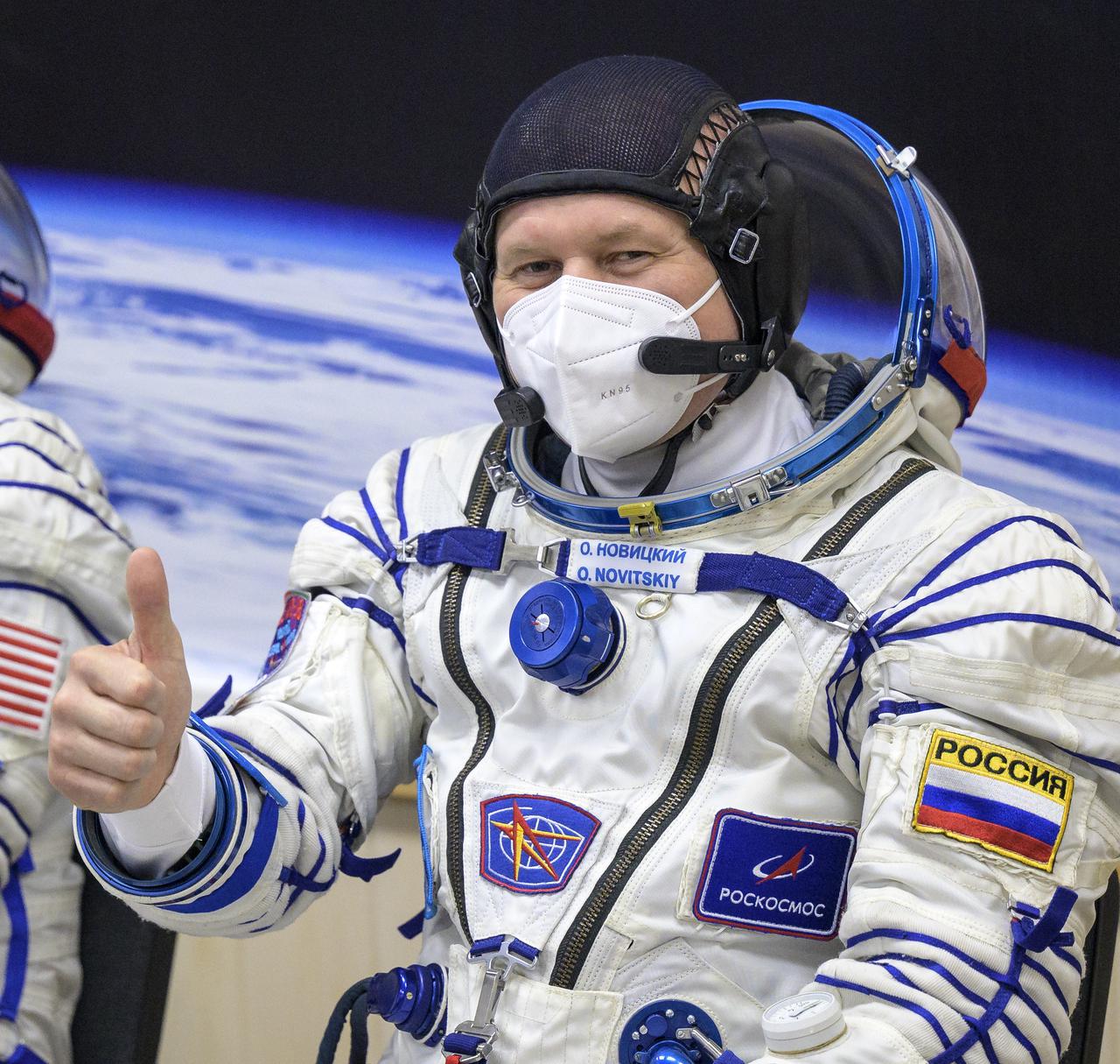 Expedition 65 Russian cosmonaut Oleg Novitskiy weaves after donning his Russian Sokol suit as he and fellow crewmates Russian cosmonaut Pyotr Dubrov and NASA astronaut Mark Vande Hei, prepare for their Soyuz launch to the International Space Station Friday, April 9, 2021 in Baikonur, Kazakhstan. Launch of the Soyuz rocket sent the trio on a mission to the International Space Station. Photo Credit: (NASA/Bill Ingalls)