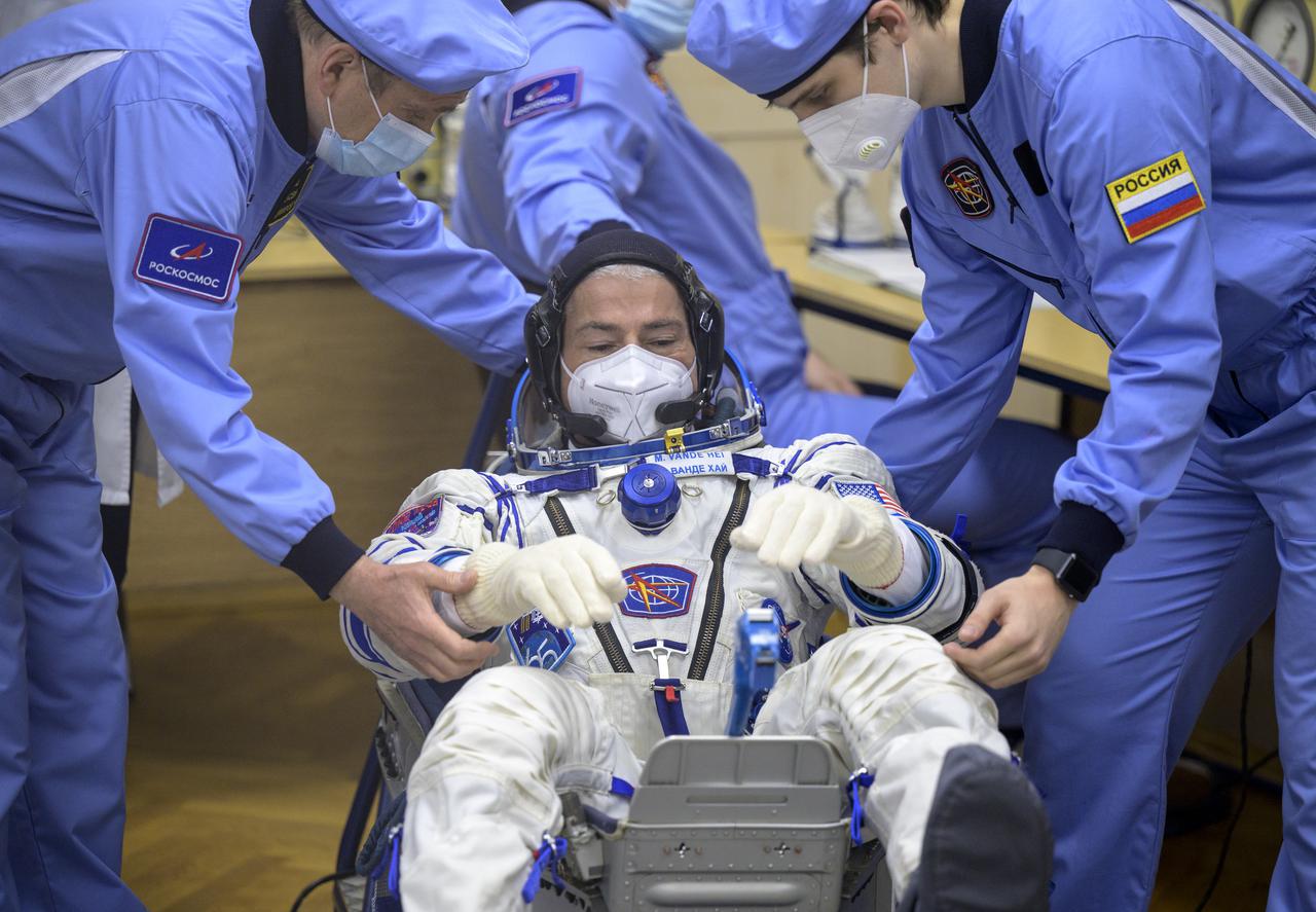 Expedition 65 NASA astronaut Mark Vande Hei has his Russian Sokol suit pressure checked as he and fellow crewmates Russian cosmonauts Oleg Novitskiy and Pyotr Dubrov, prepare for their Soyuz launch to the International Space Station Friday, April 9, 2021 in Baikonur, Kazakhstan. Launch of the Soyuz rocket sent the trio on a mission to the International Space Station. Photo Credit: (NASA/Bill Ingalls)