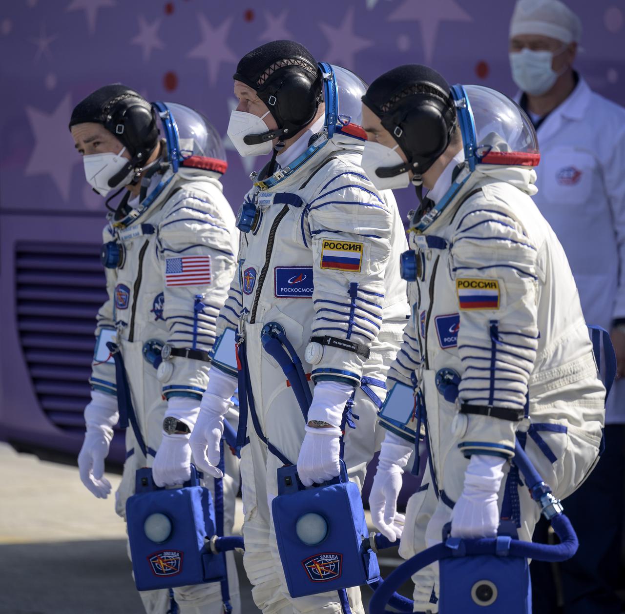 Expedition 65 NASA astronaut Mark Vande Hei, left, Russian cosmonauts Oleg Novitskiy, center, and Pyotr Dubrov arrive at the launch pad to board the Soyuz MS-18 spacecraft for launch, Friday, April 9, 2021 at the Baikonur Cosmodrome in Kazakhstan. Launch of the Soyuz rocket sent the trio on a mission to the International Space Station. Photo Credit: (NASA/Bill Ingalls)