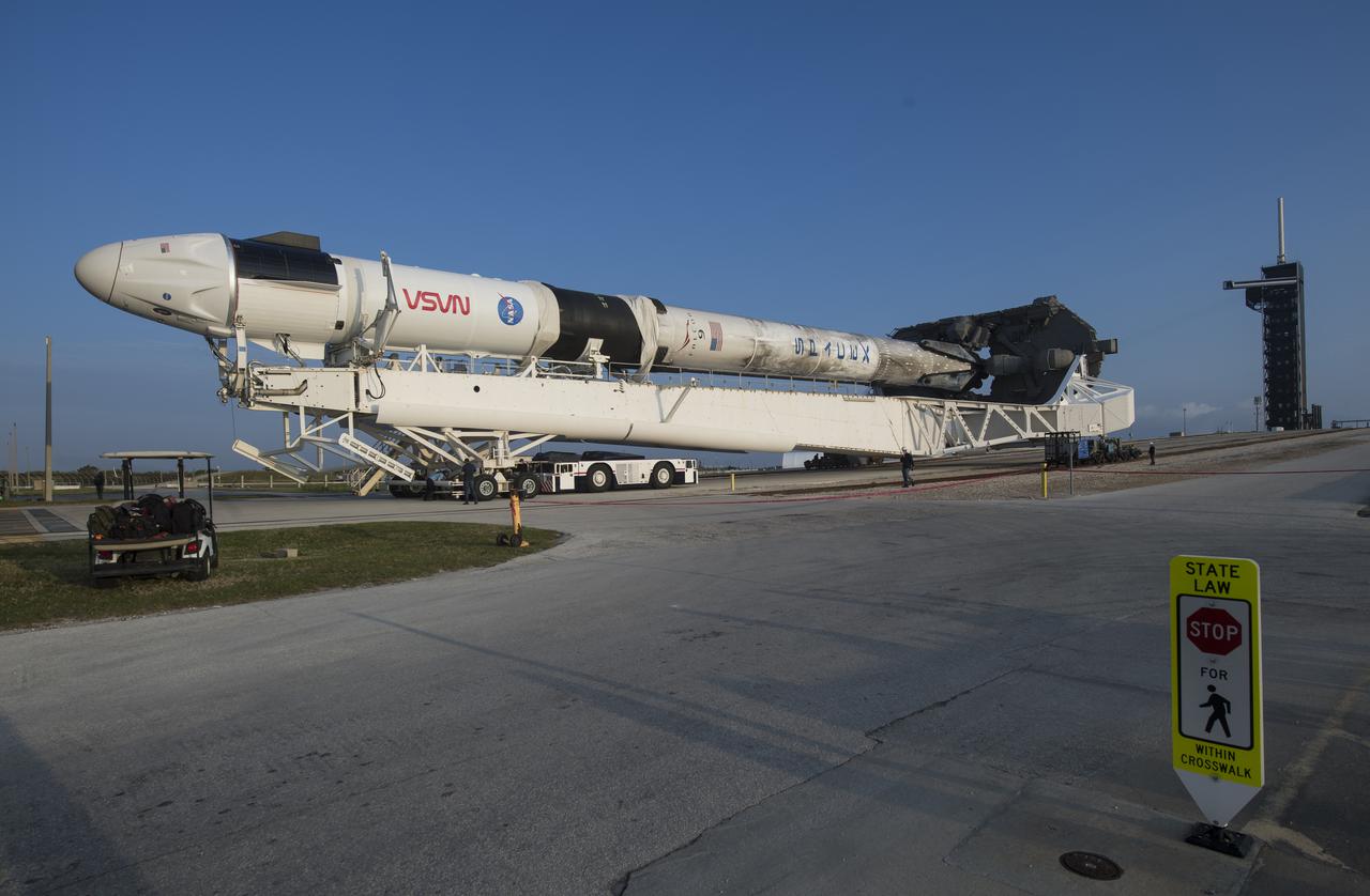 A SpaceX Falcon 9 rocket with the company's Crew Dragon spacecraft onboard is seen as it is rolled to Launch Complex 39A as preparations continue for the Crew-2 mission, Friday, April 16, 2021, at NASA’s Kennedy Space Center in Florida. NASA’s SpaceX Crew-2 mission is the second crew rotation mission of the SpaceX Crew Dragon spacecraft and Falcon 9 rocket to the International Space Station as part of the agency’s Commercial Crew Program. NASA astronauts Shane Kimbrough and Megan McArthur, ESA (European Space Agency) astronaut Thomas Pesquet, and Japan Aerospace Exploration Agency (JAXA) astronaut Akihiko Hoshide are scheduled to launch at 6:11 a.m. ET on Thursday, April 22, from Launch Complex 39A at the Kennedy Space Center. Photo Credit: (NASA/Aubrey Gemignani)