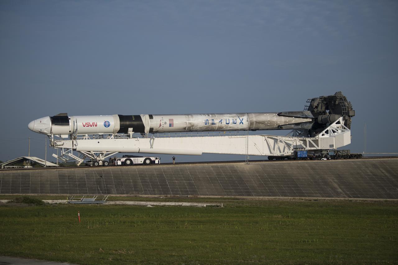 A SpaceX Falcon 9 rocket with the company's Crew Dragon spacecraft onboard is seen as it is rolled to Launch Complex 39A as preparations continue for the Crew-2 mission, Friday, April 16, 2021, at NASA’s Kennedy Space Center in Florida. NASA’s SpaceX Crew-2 mission is the second crew rotation mission of the SpaceX Crew Dragon spacecraft and Falcon 9 rocket to the International Space Station as part of the agency’s Commercial Crew Program. NASA astronauts Shane Kimbrough and Megan McArthur, ESA (European Space Agency) astronaut Thomas Pesquet, and Japan Aerospace Exploration Agency (JAXA) astronaut Akihiko Hoshide are scheduled to launch at 6:11 a.m. ET on Thursday, April 22, from Launch Complex 39A at the Kennedy Space Center. Photo Credit: (NASA/Aubrey Gemignani)