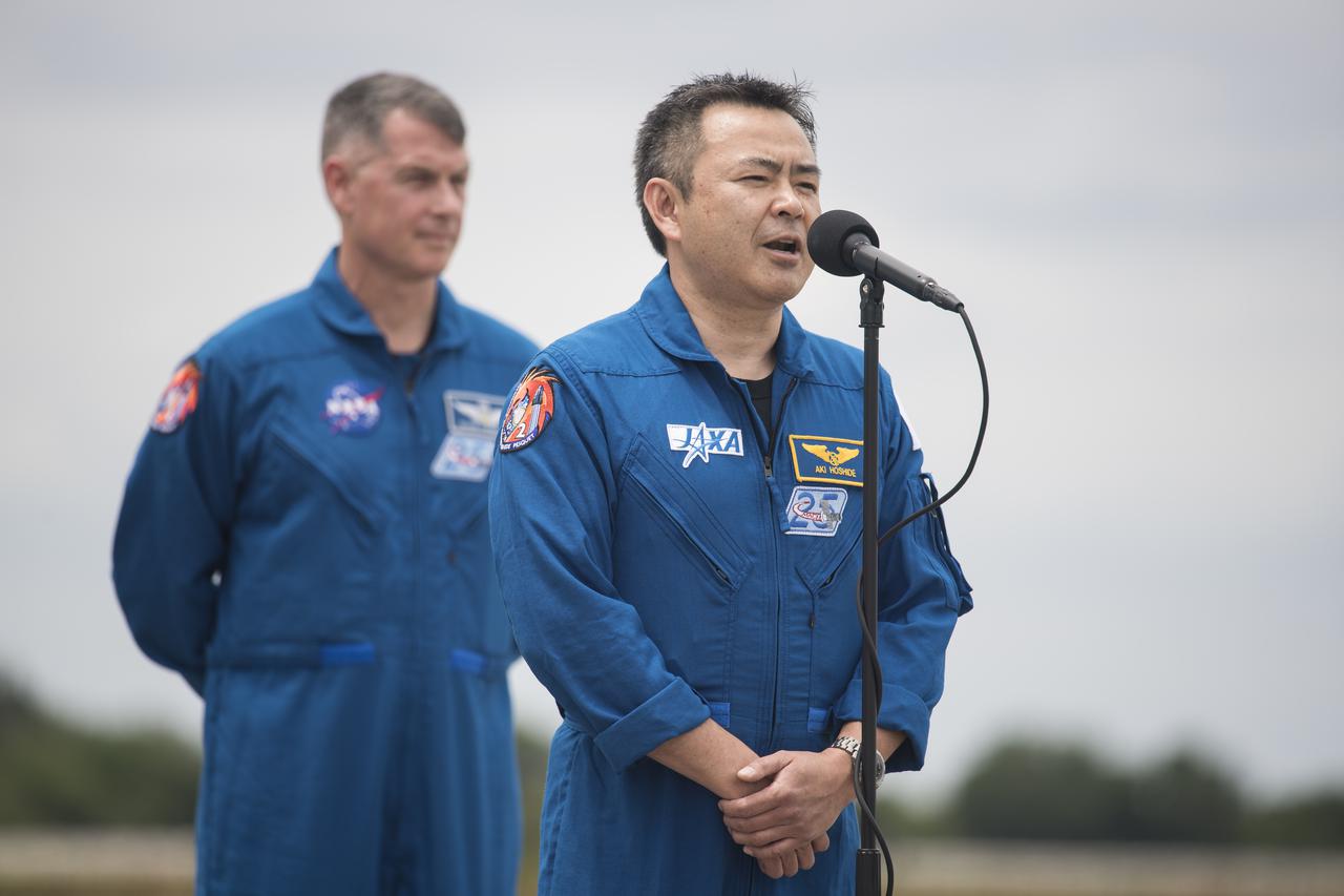 Japan Aerospace Exploration Agency (JAXA) astronaut Akihiko Hoshide, answers a question from media as crew mate NASA astronaut Shane Kimbrough looks on, after they arrived at the Launch and Landing Facility at NASA’s Kennedy Space Center ahead of SpaceX’s Crew-2 mission, Friday, April 16, 2021, in Florida. NASA’s SpaceX Crew-2 mission is the second operational mission of the SpaceX Crew Dragon spacecraft and Falcon 9 rocket to the International Space Station as part of the agency’s Commercial Crew Program. Hoshide, Kimbrough, NASA astronaut Megan McArthur, and ESA (European Space Agency) astronaut Thomas Pesquet are scheduled to launch at 6:11 a.m. ET on Thursday, April 22, from Launch Complex 39A at the Kennedy Space Center. Photo Credit: (NASA/Aubrey Gemignani)