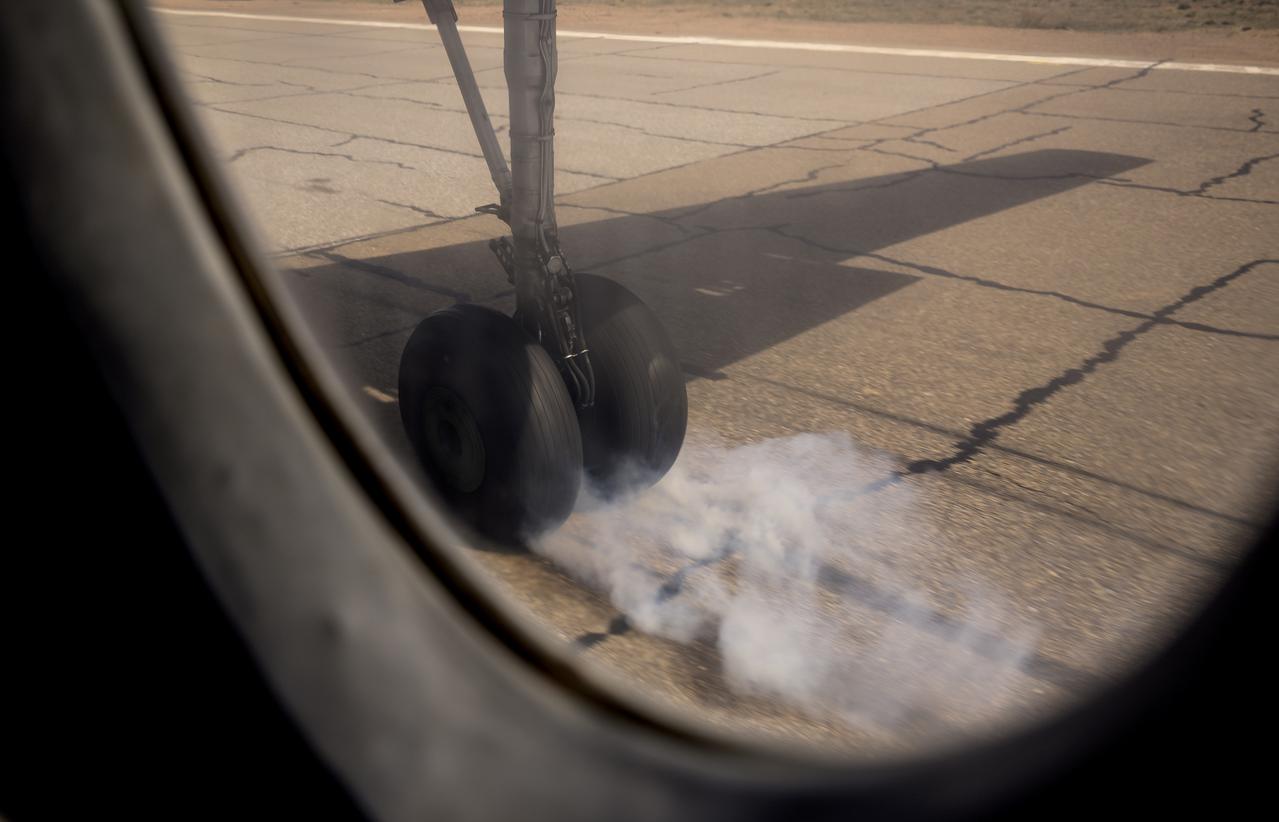 Wheels of a Russian AN-26 aircraft make contact as teams from NASA, Roscosmos, and Russian Search and Recovery Forces stage in Zhezkazgan, Kazakhstan for the landing of Expedition 64 crew members Kate Rubins of NASA, Sergey Ryzhikov and Sergey Kud-Sverchkov of Roscosmos, Friday, April 16, 2021. Rubins, Ryzhikov and Kud-Sverchkov will be returning April 17 after 185 days in space having served as Expedition 63-64 crew members onboard the International Space Station. Photo Credit: NASA/Bill Ingalls