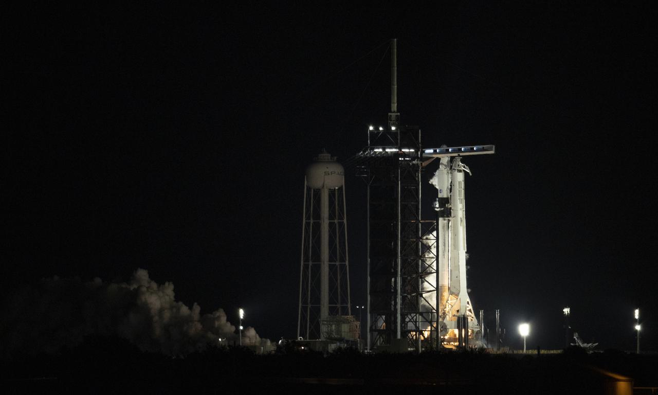 A SpaceX Falcon 9 rocket with the company's Crew Dragon spacecraft onboard is seen on the launch pad at Launch Complex 39A during a brief static fire test ahead of NASA’s SpaceX Crew-2 mission, Saturday, April 17, 2021, at NASA’s Kennedy Space Center in Florida. NASA’s SpaceX Crew-2 mission is the second crew rotation mission of the SpaceX Crew Dragon spacecraft and Falcon 9 rocket to the International Space Station as part of the agency’s Commercial Crew Program. NASA astronauts Shane Kimbrough and Megan McArthur, ESA (European Space Agency) astronaut Thomas Pesquet, and Japan Aerospace Exploration Agency (JAXA) astronaut Akihiko Hoshide are scheduled to launch at 6:11 a.m. ET on Thursday, April 22, from Launch Complex 39A at the Kennedy Space Center. Photo Credit: (NASA/Joel Kowsky)