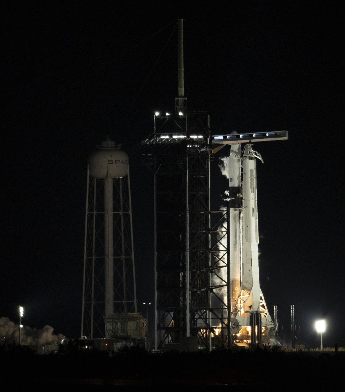 A SpaceX Falcon 9 rocket with the company's Crew Dragon spacecraft onboard is seen on the launch pad at Launch Complex 39A during a brief static fire test ahead of NASA’s SpaceX Crew-2 mission, Saturday, April 17, 2021, at NASA’s Kennedy Space Center in Florida. NASA’s SpaceX Crew-2 mission is the second crew rotation mission of the SpaceX Crew Dragon spacecraft and Falcon 9 rocket to the International Space Station as part of the agency’s Commercial Crew Program. NASA astronauts Shane Kimbrough and Megan McArthur, ESA (European Space Agency) astronaut Thomas Pesquet, and Japan Aerospace Exploration Agency (JAXA) astronaut Akihiko Hoshide are scheduled to launch at 6:11 a.m. ET on Thursday, April 22, from Launch Complex 39A at the Kennedy Space Center. Photo Credit: (NASA/Joel Kowsky)