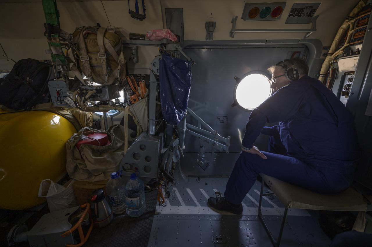 Deputy Head of the Search-and-Rescue Department of Rosaviatsiya (Russian Federal Air Transport Agency) Aleksey Lukiyanov waits as his helicopter flies to the landing zone of the Soyuz MS-17 with Expedition 64 crew members Kate Rubins of NASA, Sergey Ryzhikov and Sergey Kud-Sverchkov of Roscosmos onboard, Saturday, April 17, 2021. Rubins, Ryzhikov and Kud-Sverchkov returned after 185 days in space having served as Expedition 63-64 crew members onboard the International Space Station. Photo Credit: NASA/Bill Ingalls