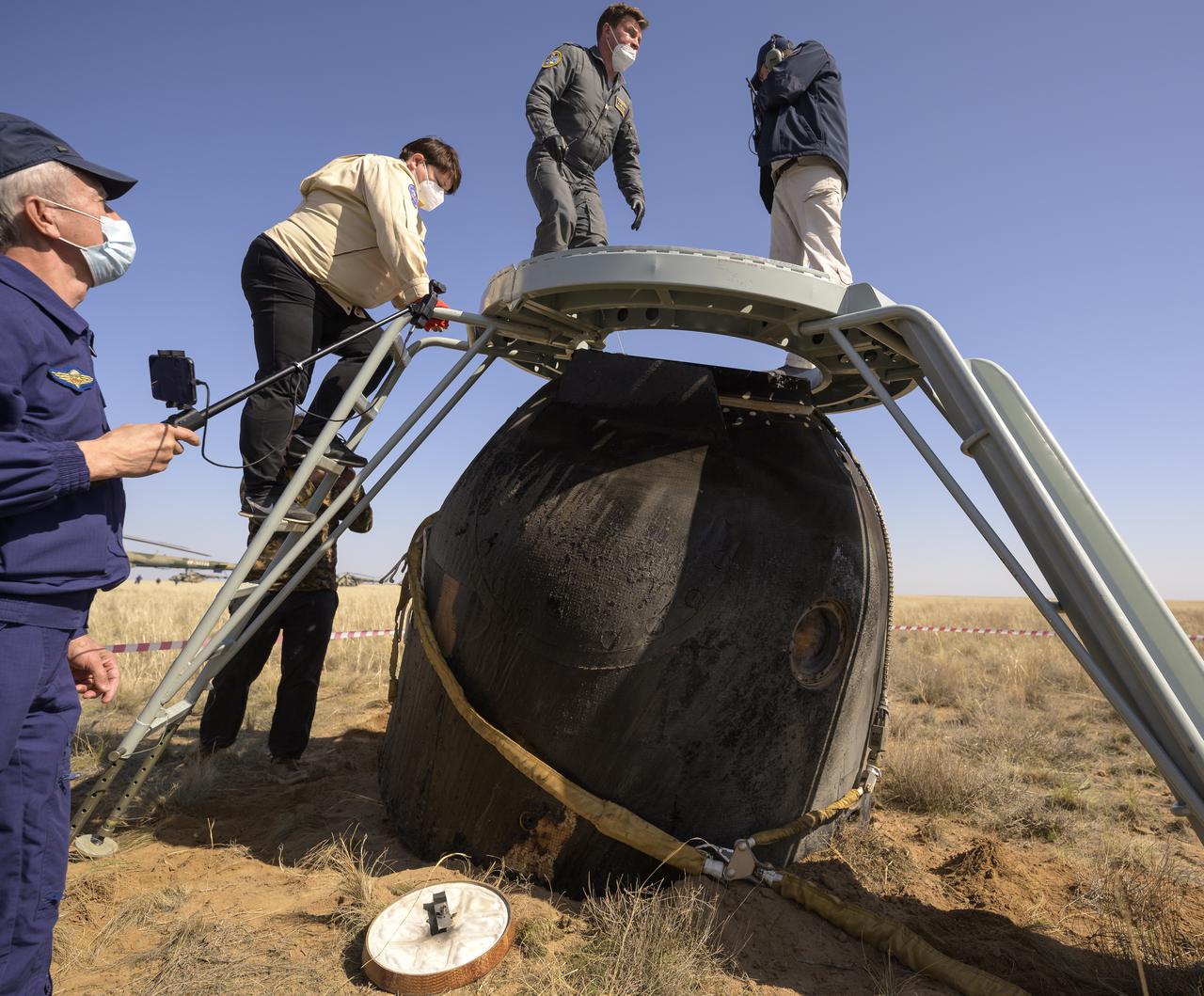 Russian Search and Rescue teams arrive at the Soyuz MS-17 spacecraft shortly after it landed in a remote area near the town of Zhezkazgan, Kazakhstan with Expedition 64 crew members Kate Rubins of NASA, Sergey Ryzhikov and Sergey Kud-Sverchkov of Roscosmos, Saturday, April 17, 2021. Rubins, Ryzhikov and Kud-Sverchkov returned after 185 days in space having served as Expedition 63-64 crew members onboard the International Space Station. Photo Credit: NASA/Bill Ingalls