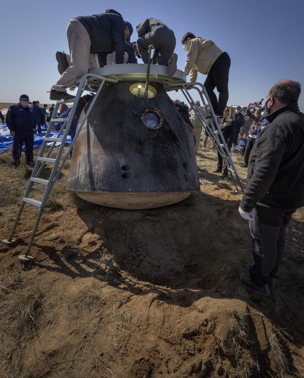 Russian Search and Rescue teams arrive at the Soyuz MS-17 spacecraft shortly after it landed in a remote area near the town of Zhezkazgan, Kazakhstan with Expedition 64 crew members Kate Rubins of NASA, Sergey Ryzhikov and Sergey Kud-Sverchkov of Roscosmos, Saturday, April 17, 2021. Rubins, Ryzhikov and Kud-Sverchkov returned after 185 days in space having served as Expedition 63-64 crew members onboard the International Space Station. Photo Credit: NASA/Bill Ingalls