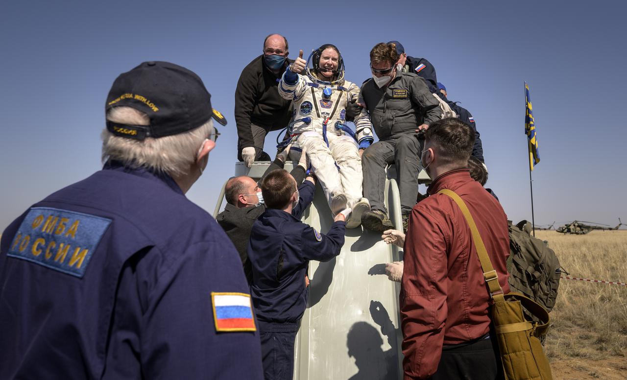 Expedition 64 NASA astronaut Kate Rubins is helped out of the Soyuz MS-17 spacecraft just minutes after she, and Roscosmos cosmonauts Sergey Kud-Sverchkov and Sergey Ryzhikov landed in a remote area near the town of Zhezkazgan, Kazakhstan on Saturday, April 17, 2021. Rubins, Ryzhikov and Kud-Sverchkov returned after 185 days in space having served as Expedition 63-64 crew members onboard the International Space Station. Photo Credit: NASA/Bill Ingalls
