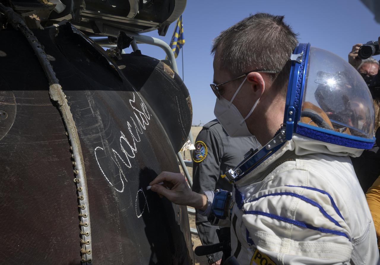 Expedition 64 Roscosmos cosmonaut Sergey Ryzhikov signs the Soyuz MS-17 spacecraft after he, Roscosmos cosmonaut Sergey Kud-Sverchkov, and NASA astronaut Kate Rubins landed in a remote area near the town of Zhezkazgan, Kazakhstan on Saturday, April 17, 2021. Rubins, Ryzhikov and Kud-Sverchkov returned after 185 days in space having served as Expedition 63-64 crew members onboard the International Space Station. Photo Credit: NASA/Bill Ingalls