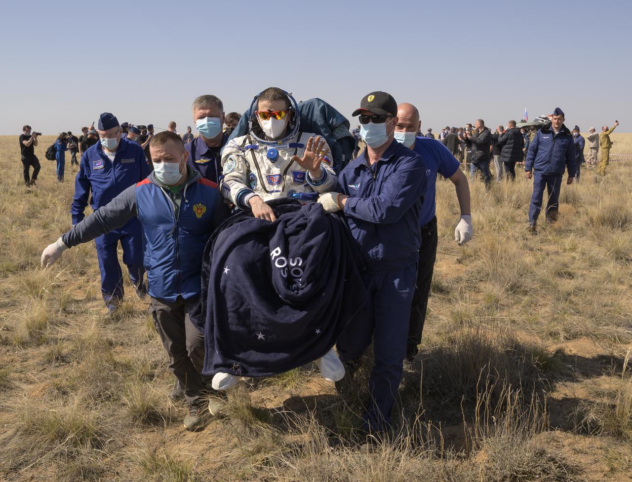 Expedition 64 Roscosmos cosmonaut Sergey Kud-Sverchkov is carried to a medical tent shortly after he, Roscosmos cosmonaut Sergey Ryzhikov, and NASA astronaut Kate Rubins landed in their Soyuz MS-17 spacecraft near the town of Zhezkazgan, Kazakhstan on Saturday, April 17, 2021. Rubins, Ryzhikov and Kud-Sverchkov returned after 185 days in space having served as Expedition 63-64 crew members onboard the International Space Station. Photo Credit: NASA/Bill Ingalls