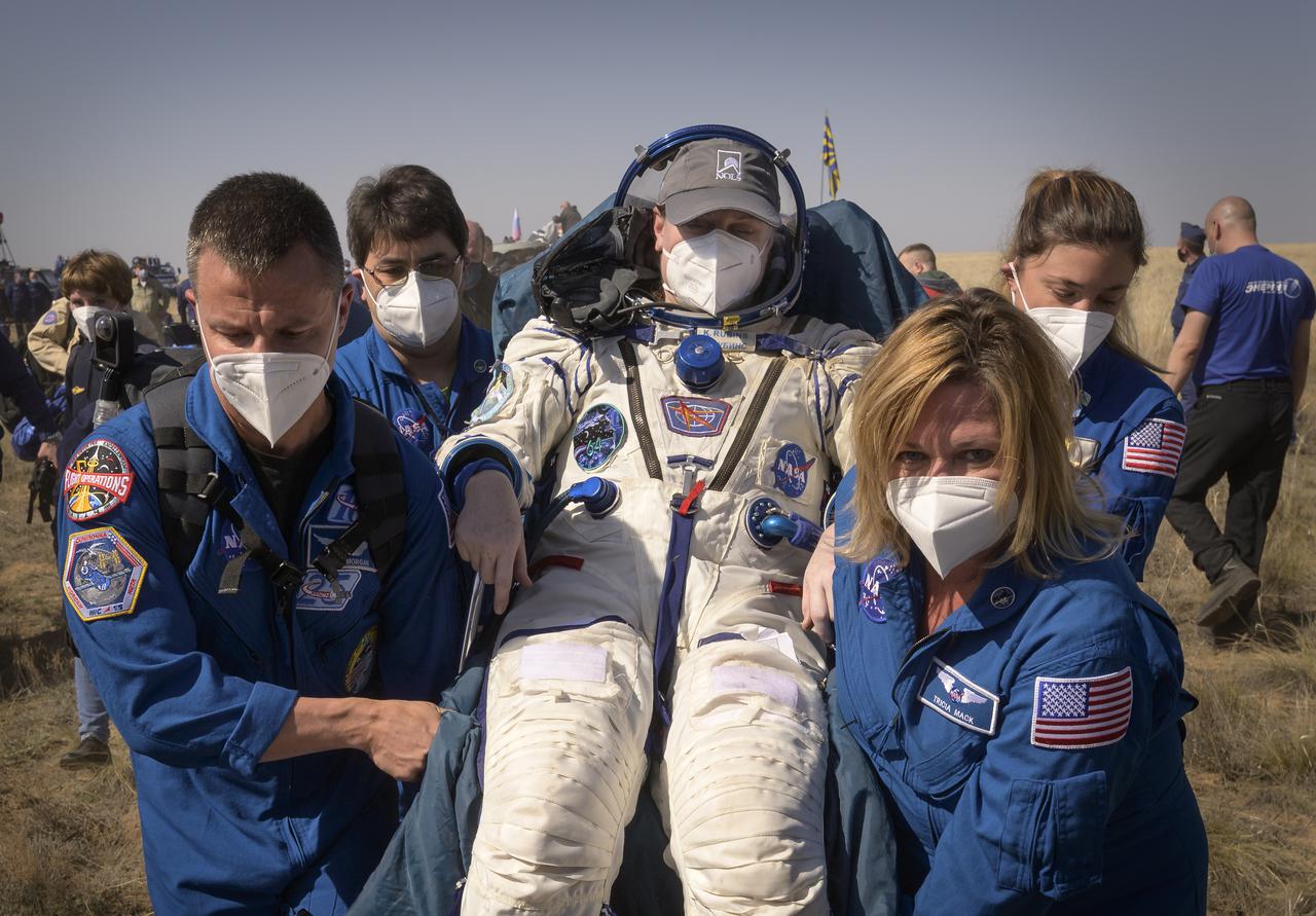 #Expedition 64 NASA astronaut Kate Rubins is carried to a medical tent by NASA Astronaut Office Representative and astronaut Drew Morgan, left, Manager, NASA ISS Transportation Integration Office, Bill Spetch, NASA Biomedical Engineer Marissa Rosenberg, and NASA Director for Human Space Flight Programs, Russia, Tricia Mack, right, shortly after she, and Roscosmos cosmonauts Sergey Ryzhikov and Sergey Kud-Sverchkov landed in their Soyuz MS-17 spacecraft near the town of Zhezkazgan, Kazakhstan on Saturday, April 17, 2021. Rubins, Ryzhikov and Kud-Sverchkov returned after 185 days in space having served as Expedition 63-64 crew members onboard the International Space Station. Photo Credit: NASA/Bill Ingalls