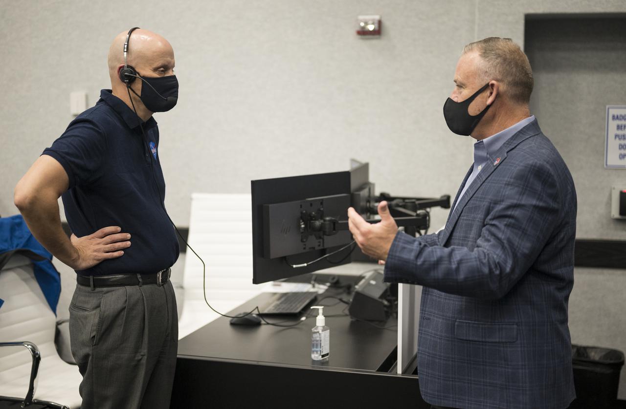 Norm Knight, deputy director of Flight Operations at NASA's Johnson Space Center, right, speaks with Stephen Koerner, director of the Flight Operations Directorate at NASA’s Johnson Space Center, left, during a dress rehearsal in preparation for the launch of a SpaceX Falcon 9 rocket carrying the company's Crew Dragon spacecraft on NASA’s SpaceX Crew-2 mission with NASA astronauts Shane Kimbrough and Megan McArthur, ESA (European Space Agency) astronaut Thomas Pesquet, and Japan Aerospace Exploration Agency (JAXA) astronaut Akihiko Hoshide onboard, Sunday, April 18, 2021, in firing room four of the Launch Control Center at NASA’s Kennedy Space Center in Florida. NASA’s SpaceX Crew-2 mission is the second operational mission of the SpaceX Crew Dragon spacecraft and Falcon 9 rocket to the International Space Station as part of the agency’s Commercial Crew Program. Kimbrough, McArthur, Pesquet, and Hoshide are scheduled to launch at 6:11 a.m. ET on Thursday, April 22, from Launch Complex 39A at the Kennedy Space Center. Photo Credit: (NASA/Joel Kowsky)