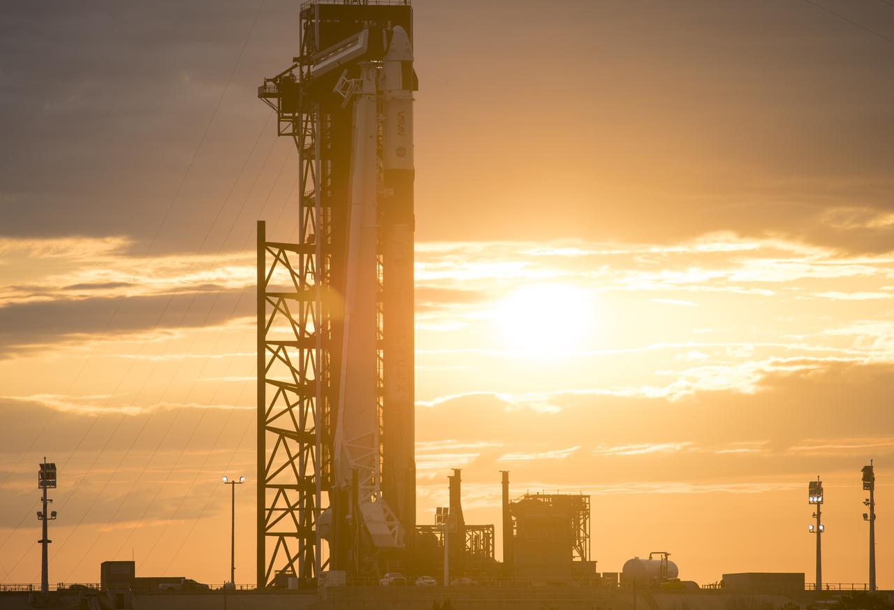 A SpaceX Falcon 9 rocket with the company's Crew Dragon spacecraft onboard is seen at sunset on the launch pad at Launch Complex 39A as preparations continue for the Crew-2 mission, Monday, April 19, 2021, at NASA’s Kennedy Space Center in Florida. NASA’s SpaceX Crew-2 mission is the second crew rotation mission of the SpaceX Crew Dragon spacecraft and Falcon 9 rocket to the International Space Station as part of the agency’s Commercial Crew Program. NASA astronauts Shane Kimbrough and Megan McArthur, ESA (European Space Agency) astronaut Thomas Pesquet, and Japan Aerospace Exploration Agency (JAXA) astronaut Akihiko Hoshide are scheduled to launch at 6:11 a.m. ET on Thursday, April 22, from Launch Complex 39A at the Kennedy Space Center. Photo Credit: (NASA/Joel Kowsky)