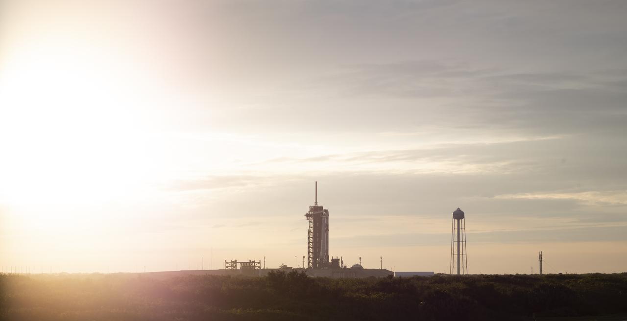 A SpaceX Falcon 9 rocket with the company's Crew Dragon spacecraft onboard is seen at sunset on the launch pad at Launch Complex 39A as preparations continue for the Crew-2 mission, Monday, April 19, 2021, at NASA’s Kennedy Space Center in Florida. NASA’s SpaceX Crew-2 mission is the second crew rotation mission of the SpaceX Crew Dragon spacecraft and Falcon 9 rocket to the International Space Station as part of the agency’s Commercial Crew Program. NASA astronauts Shane Kimbrough and Megan McArthur, ESA (European Space Agency) astronaut Thomas Pesquet, and Japan Aerospace Exploration Agency (JAXA) astronaut Akihiko Hoshide are scheduled to launch at 6:11 a.m. ET on Thursday, April 22, from Launch Complex 39A at the Kennedy Space Center. Photo Credit: (NASA/Joel Kowsky)