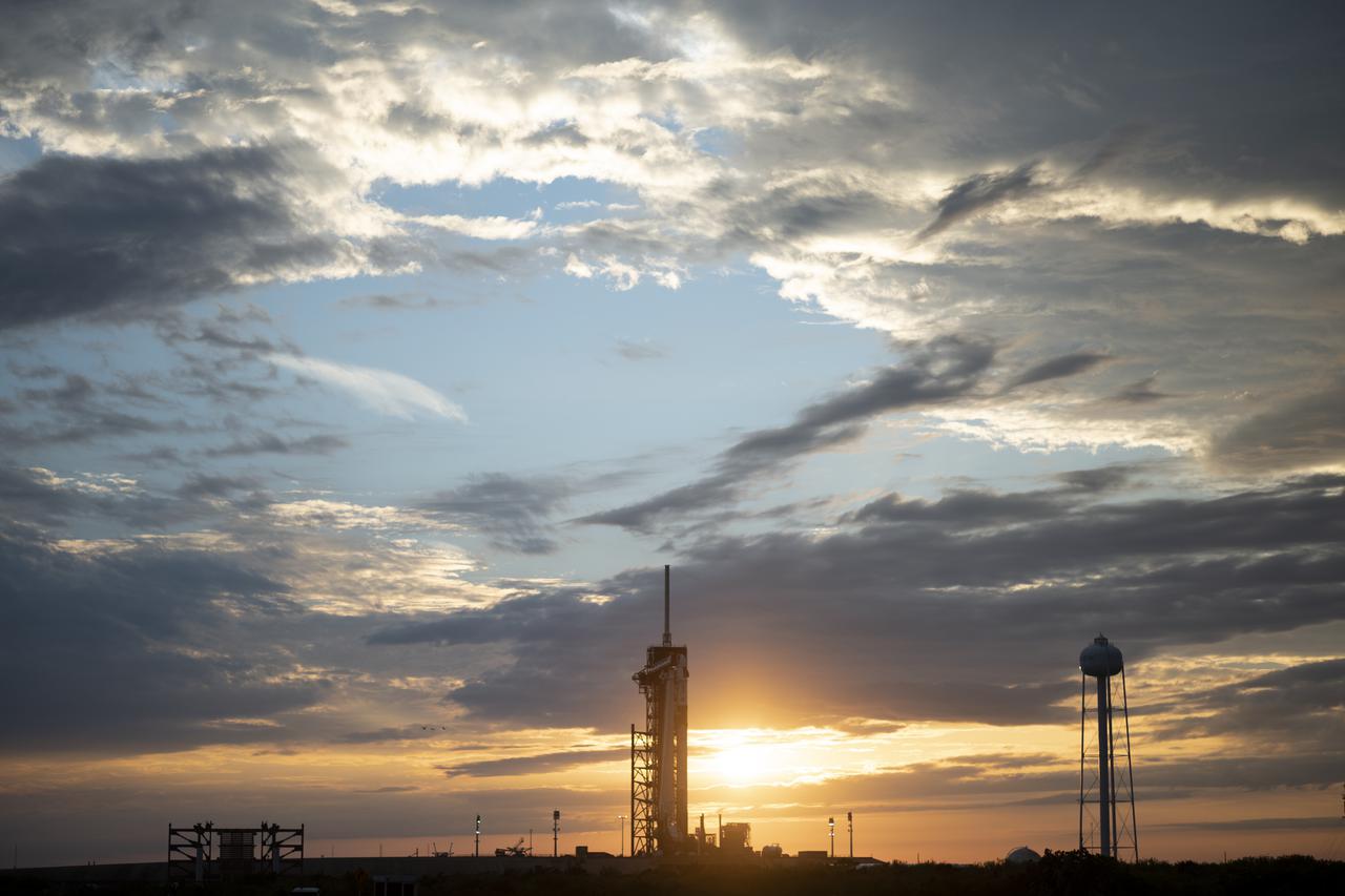 A SpaceX Falcon 9 rocket with the company's Crew Dragon spacecraft onboard is seen at sunset on the launch pad at Launch Complex 39A as preparations continue for the Crew-2 mission, Monday, April 19, 2021, at NASA’s Kennedy Space Center in Florida. NASA’s SpaceX Crew-2 mission is the second crew rotation mission of the SpaceX Crew Dragon spacecraft and Falcon 9 rocket to the International Space Station as part of the agency’s Commercial Crew Program. NASA astronauts Shane Kimbrough and Megan McArthur, ESA (European Space Agency) astronaut Thomas Pesquet, and Japan Aerospace Exploration Agency (JAXA) astronaut Akihiko Hoshide are scheduled to launch at 6:11 a.m. ET on Thursday, April 22, from Launch Complex 39A at the Kennedy Space Center. Photo Credit: (NASA/Joel Kowsky)