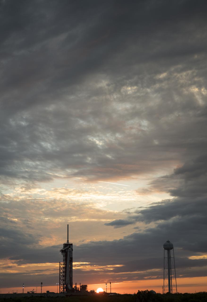 A SpaceX Falcon 9 rocket with the company's Crew Dragon spacecraft onboard is seen at sunset on the launch pad at Launch Complex 39A as preparations continue for the Crew-2 mission, Monday, April 19, 2021, at NASA’s Kennedy Space Center in Florida. NASA’s SpaceX Crew-2 mission is the second crew rotation mission of the SpaceX Crew Dragon spacecraft and Falcon 9 rocket to the International Space Station as part of the agency’s Commercial Crew Program. NASA astronauts Shane Kimbrough and Megan McArthur, ESA (European Space Agency) astronaut Thomas Pesquet, and Japan Aerospace Exploration Agency (JAXA) astronaut Akihiko Hoshide are scheduled to launch at 6:11 a.m. ET on Thursday, April 22, from Launch Complex 39A at the Kennedy Space Center. Photo Credit: (NASA/Joel Kowsky)