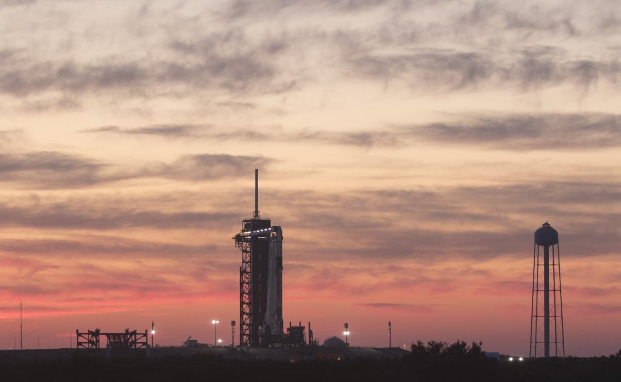 A SpaceX Falcon 9 rocket with the company's Crew Dragon spacecraft onboard is seen at sunset on the launch pad at Launch Complex 39A as preparations continue for the Crew-2 mission, Wednesday, April 21, 2021, at NASA’s Kennedy Space Center in Florida. NASA’s SpaceX Crew-2 mission is the second crew rotation mission of the SpaceX Crew Dragon spacecraft and Falcon 9 rocket to the International Space Station as part of the agency’s Commercial Crew Program. NASA astronauts Shane Kimbrough and Megan McArthur, ESA (European Space Agency) astronaut Thomas Pesquet, and Japan Aerospace Exploration Agency (JAXA) astronaut Akihiko Hoshide are scheduled to launch at 5:49 a.m. EDT on Friday, April 23, from Launch Complex 39A at the Kennedy Space Center. Photo Credit: (NASA/Joel Kowsky)