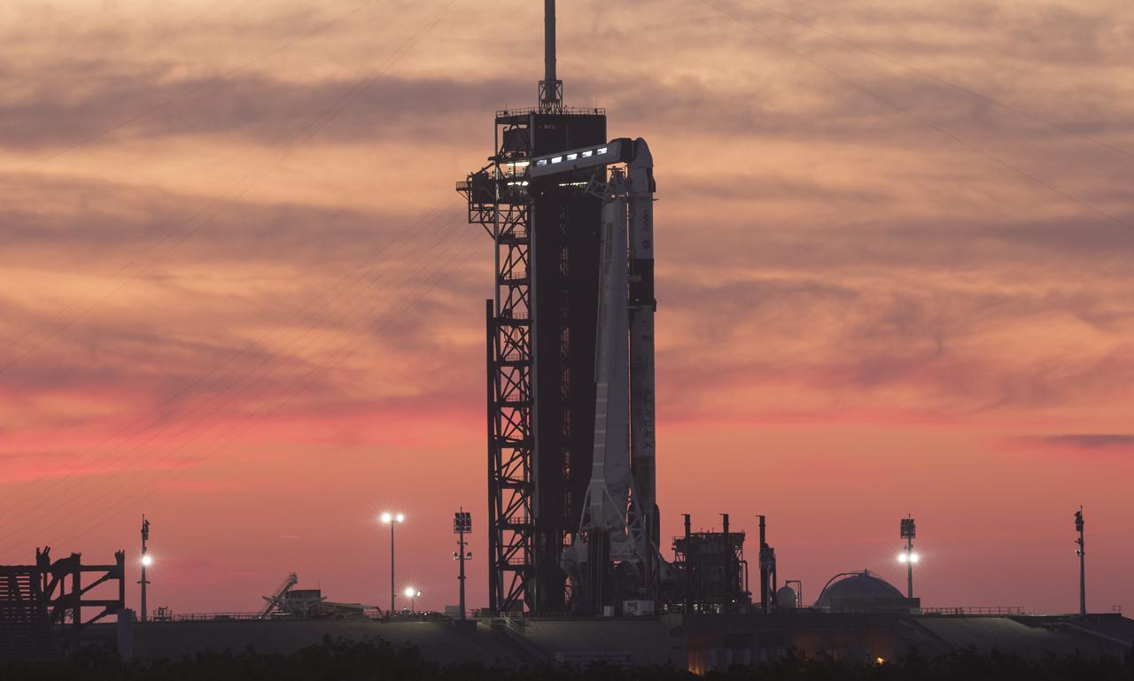 A SpaceX Falcon 9 rocket with the company's Crew Dragon spacecraft onboard is seen at sunset on the launch pad at Launch Complex 39A as preparations continue for the Crew-2 mission, Wednesday, April 21, 2021, at NASA’s Kennedy Space Center in Florida. NASA’s SpaceX Crew-2 mission is the second crew rotation mission of the SpaceX Crew Dragon spacecraft and Falcon 9 rocket to the International Space Station as part of the agency’s Commercial Crew Program. NASA astronauts Shane Kimbrough and Megan McArthur, ESA (European Space Agency) astronaut Thomas Pesquet, and Japan Aerospace Exploration Agency (JAXA) astronaut Akihiko Hoshide are scheduled to launch at 5:49 a.m. EDT on Friday, April 23, from Launch Complex 39A at the Kennedy Space Center. Photo Credit: (NASA/Joel Kowsky)