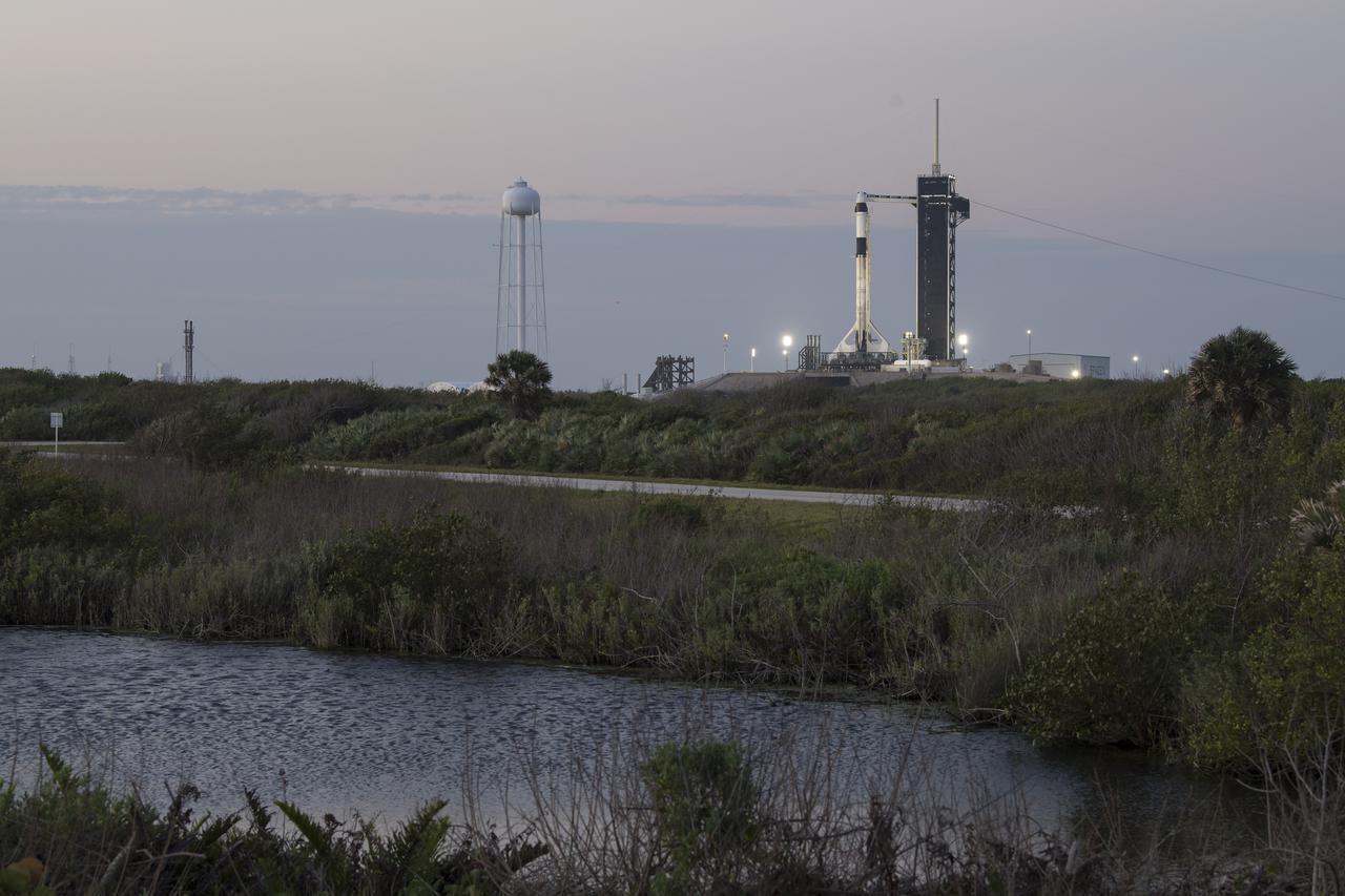 A SpaceX Falcon 9 rocket with the company's Crew Dragon spacecraft onboard is seen at sunrise on the launch pad at Launch Complex 39A as preparations continue for the Crew-2 mission, Thursday, April 22, 2021, at NASA’s Kennedy Space Center in Florida. NASA’s SpaceX Crew-2 mission is the second crew rotation mission of the SpaceX Crew Dragon spacecraft and Falcon 9 rocket to the International Space Station as part of the agency’s Commercial Crew Program. NASA astronauts Shane Kimbrough and Megan McArthur, ESA (European Space Agency) astronaut Thomas Pesquet, and Japan Aerospace Exploration Agency (JAXA) astronaut Akihiko Hoshide are scheduled to launch at 5:49 a.m. EDT on Friday, April 23, from Launch Complex 39A at the Kennedy Space Center. Photo Credit: (NASA/Aubrey Gemignani)