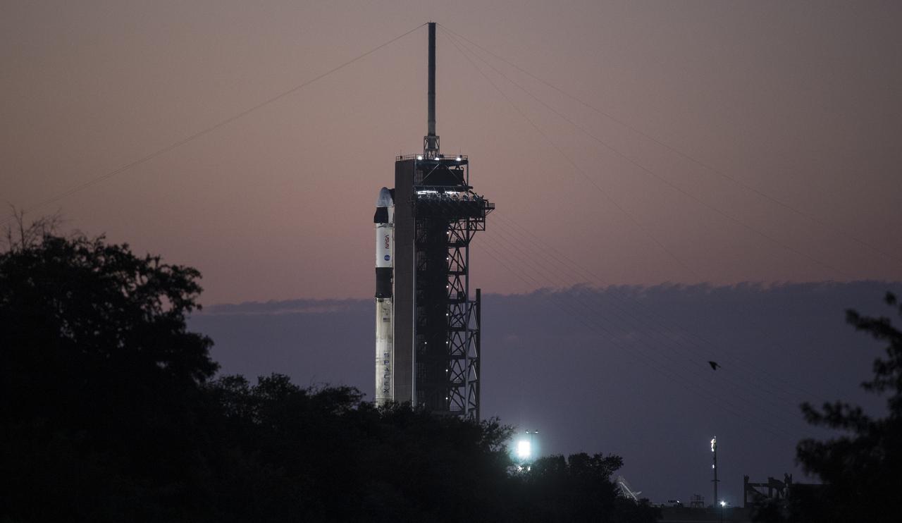 A SpaceX Falcon 9 rocket with the company's Crew Dragon spacecraft onboard is seen at sunrise on the launch pad at Launch Complex 39A as preparations continue for the Crew-2 mission, Thursday, April 22, 2021, at NASA’s Kennedy Space Center in Florida. NASA’s SpaceX Crew-2 mission is the second crew rotation mission of the SpaceX Crew Dragon spacecraft and Falcon 9 rocket to the International Space Station as part of the agency’s Commercial Crew Program. NASA astronauts Shane Kimbrough and Megan McArthur, ESA (European Space Agency) astronaut Thomas Pesquet, and Japan Aerospace Exploration Agency (JAXA) astronaut Akihiko Hoshide are scheduled to launch at 5:49 a.m. EDT on Friday, April 23, from Launch Complex 39A at the Kennedy Space Center. Photo Credit: (NASA/Joel Kowsky)