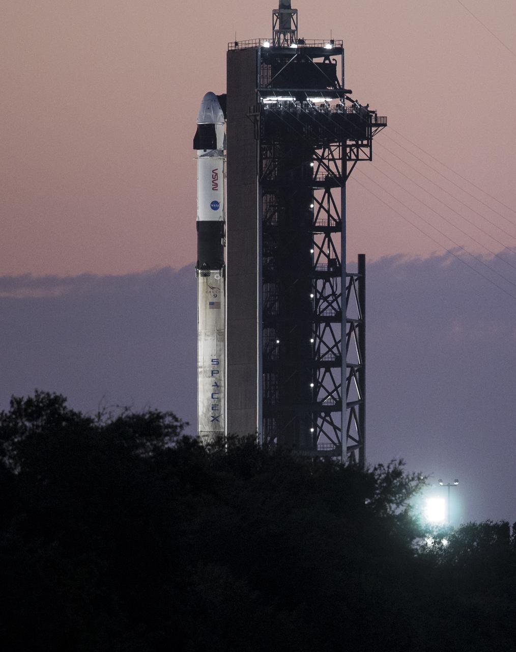 A SpaceX Falcon 9 rocket with the company's Crew Dragon spacecraft onboard is seen at sunrise on the launch pad at Launch Complex 39A as preparations continue for the Crew-2 mission, Thursday, April 22, 2021, at NASA’s Kennedy Space Center in Florida. NASA’s SpaceX Crew-2 mission is the second crew rotation mission of the SpaceX Crew Dragon spacecraft and Falcon 9 rocket to the International Space Station as part of the agency’s Commercial Crew Program. NASA astronauts Shane Kimbrough and Megan McArthur, ESA (European Space Agency) astronaut Thomas Pesquet, and Japan Aerospace Exploration Agency (JAXA) astronaut Akihiko Hoshide are scheduled to launch at 5:49 a.m. EDT on Friday, April 23, from Launch Complex 39A at the Kennedy Space Center. Photo Credit: (NASA/Joel Kowsky)