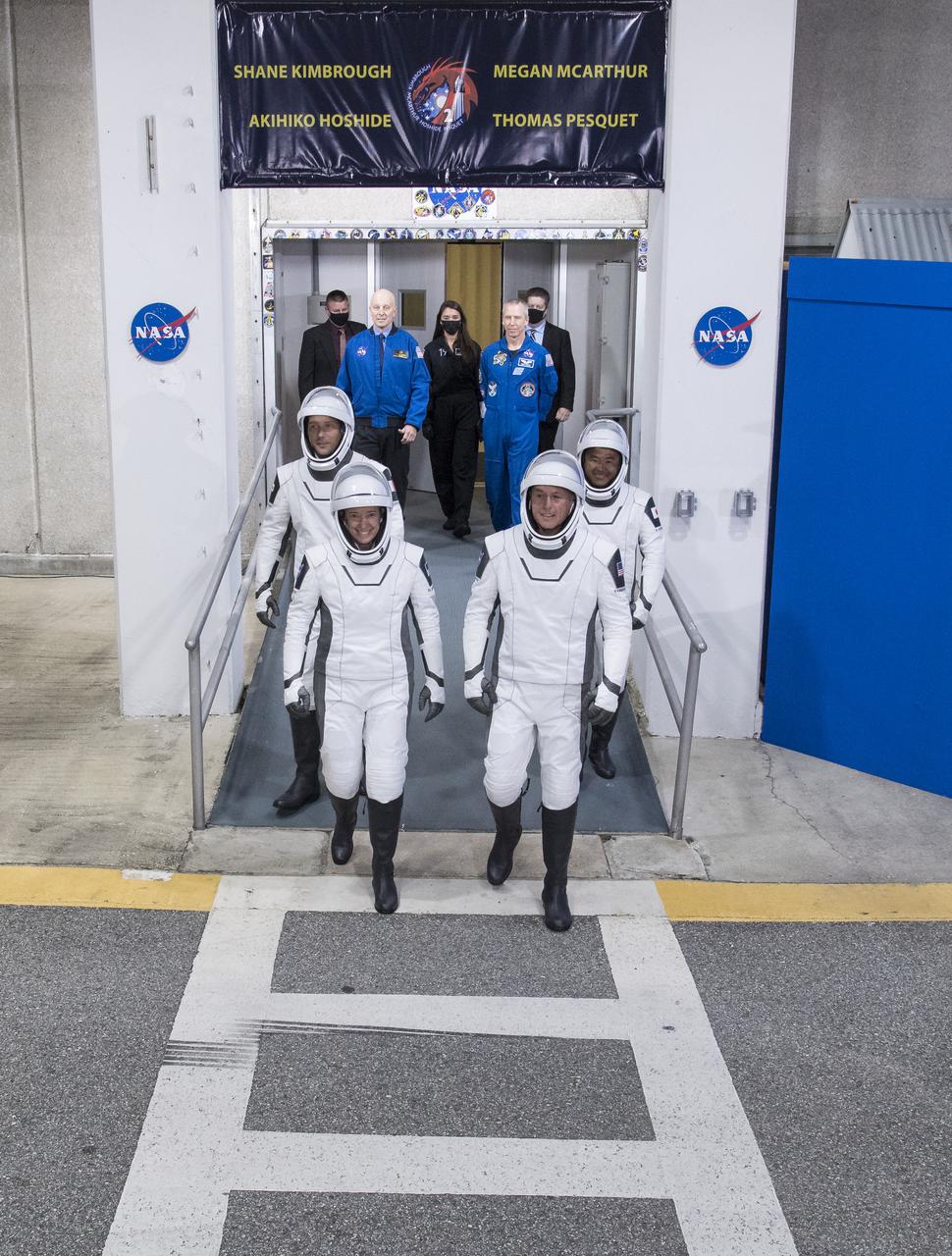 ESA (European Space Agency) astronaut Thomas Pesquet, back left, NASA astronauts Megan McArthur, front left, and Shane Kimbrough, front right, and Japan Aerospace Exploration Agency (JAXA) astronaut Akihiko Hoshide, back right, wearing SpaceX spacesuits, are seen as they prepare to depart the Neil  A. Armstrong Operations and Checkout Building for Launch Complex 39A to board the SpaceX Crew Dragon spacecraft for the Crew-2 mission launch, Friday, April 23, 2021, at NASA’s Kennedy Space Center in Florida. NASA’s SpaceX Crew-2 mission is the second crew rotation mission of the SpaceX Crew Dragon spacecraft and Falcon 9 rocket to the International Space Station as part of the agency’s Commercial Crew Program. Kimbrough, McArthur, Pesquet, and Hoshide are scheduled to launch at 5:49 a.m. EDT. Photo Credit: (NASA/Aubrey Gemignani)