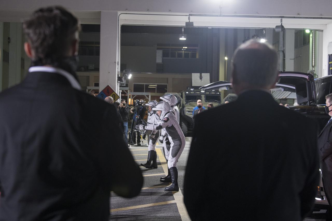 SpaceX Chief Engineer Elon Musk, left, and Acting NASA Administrator Steve Jurczyk, right, watch as ESA (European Space Agency) astronaut Thomas Pesquet, Japan Aerospace Exploration Agency (JAXA) astronaut Akihiko Hoshide, and NASA astronauts Shane Kimbrough and Megan McArthur, prepare to depart the Neil  A. Armstrong Operations and Checkout Building for Launch Complex 39A to board the SpaceX Crew Dragon spacecraft for the Crew-2 mission launch, Friday, April 23, 2021, at NASA’s Kennedy Space Center in Florida. NASA’s SpaceX Crew-2 mission is the second crew rotation mission of the SpaceX Crew Dragon spacecraft and Falcon 9 rocket to the International Space Station as part of the agency’s Commercial Crew Program. Kimbrough, McArthur, Pesquet, and Hoshide are scheduled to launch at 5:49 a.m. EDT. Photo Credit: (NASA/Aubrey Gemignani)