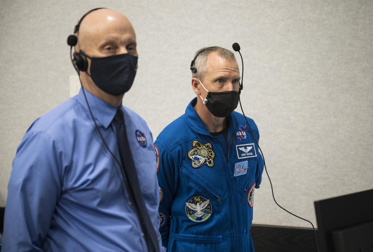 Stephen Koerner, director of the Flight Operations Directorate at NASA’s Johnson Space Center, left, and Andrew Feustel, deputy chief of the Astronaut Office, right, monitor the launch of a SpaceX Falcon 9 rocket carrying the company's Crew Dragon spacecraft on the Crew-2 mission with NASA astronauts Shane Kimbrough and Megan McArthur, ESA (European Space Agency) astronaut Thomas Pesquet, and Japan Aerospace Exploration Agency (JAXA) astronaut Akihiko Hoshide onboard, Friday, April 23, 2021, in  firing room four of the Launch Control Center at NASA’s Kennedy Space Center in Florida. NASA’s SpaceX Crew-2 mission is the second crew rotation mission of the SpaceX Crew Dragon spacecraft and Falcon 9 rocket to the International Space Station as part of the agency’s Commercial Crew Program. Kimbrough, McArthur, Pesquet, and Hoshide launched at 5:49 a.m. EDT, from Launch Complex 39A at the Kennedy Space Center. Photo Credit: (NASA/Joel Kowsky)