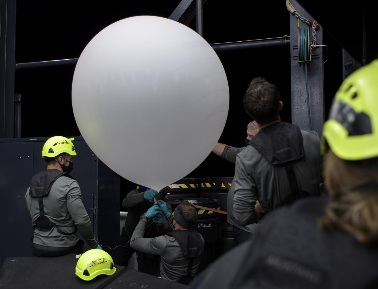 SpaceX support teams onboard the SpaceX GO Navigator recovery ship prepare to launch a weather balloon ahead of the landing of the SpaceX Crew Dragon Resilience spacecraft with NASA astronauts Mike Hopkins, Shannon Walker, and Victor Glover, and Japan Aerospace Exploration Agency (JAXA) astronaut Soichi Noguchi aboard in the Gulf of Mexico off the coast of Panama City, Florida, Saturday, May 1, 2021. NASA’s SpaceX Crew-1 mission is the first crew rotation flight of the SpaceX Crew Dragon spacecraft and Falcon 9 rocket with astronauts to the International Space Station as part of the agency’s Commercial Crew Program. Photo Credit: (NASA/Bill Ingalls)